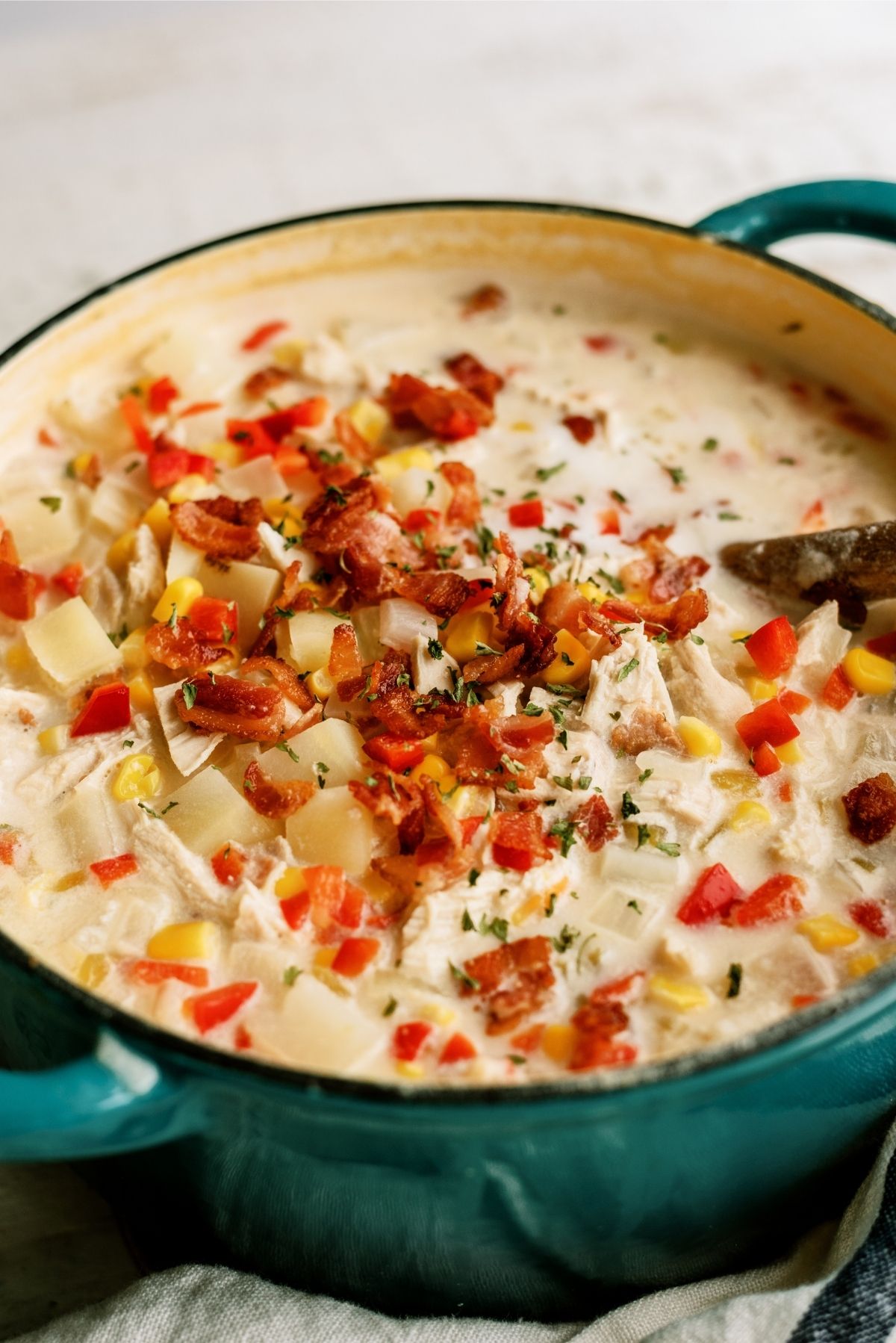 Chicken Corn Chowder in a stock pot cooked and topped with bacon