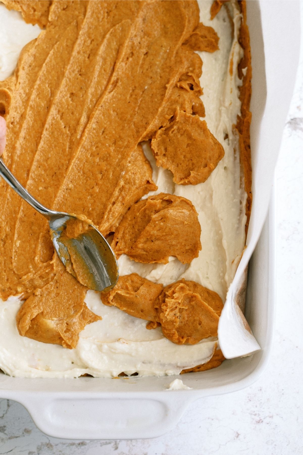 Pumpkin mixture dropped over cream cheese layer
