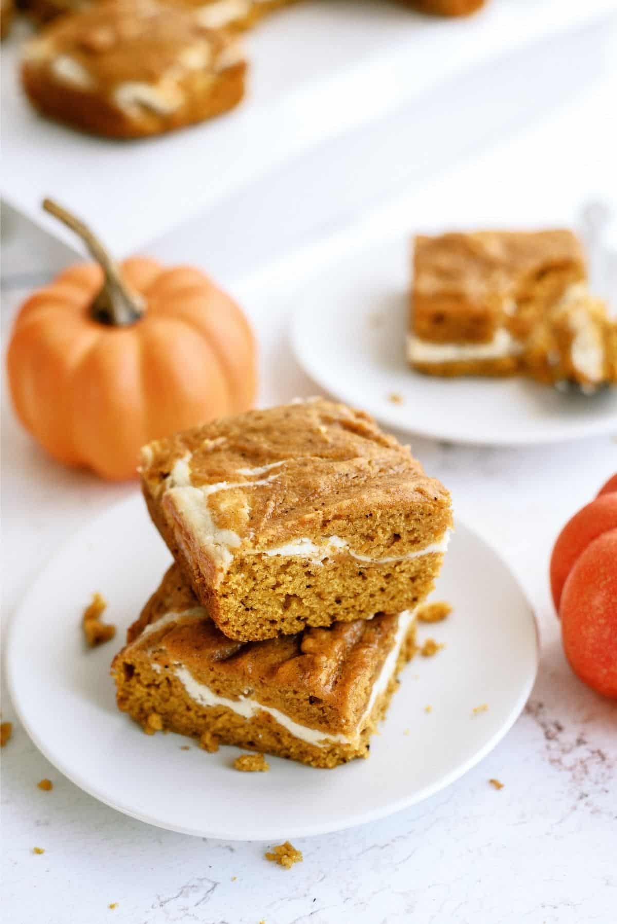 2 Cream Cheese and Pumpkin Roll Bars stacked on a plate