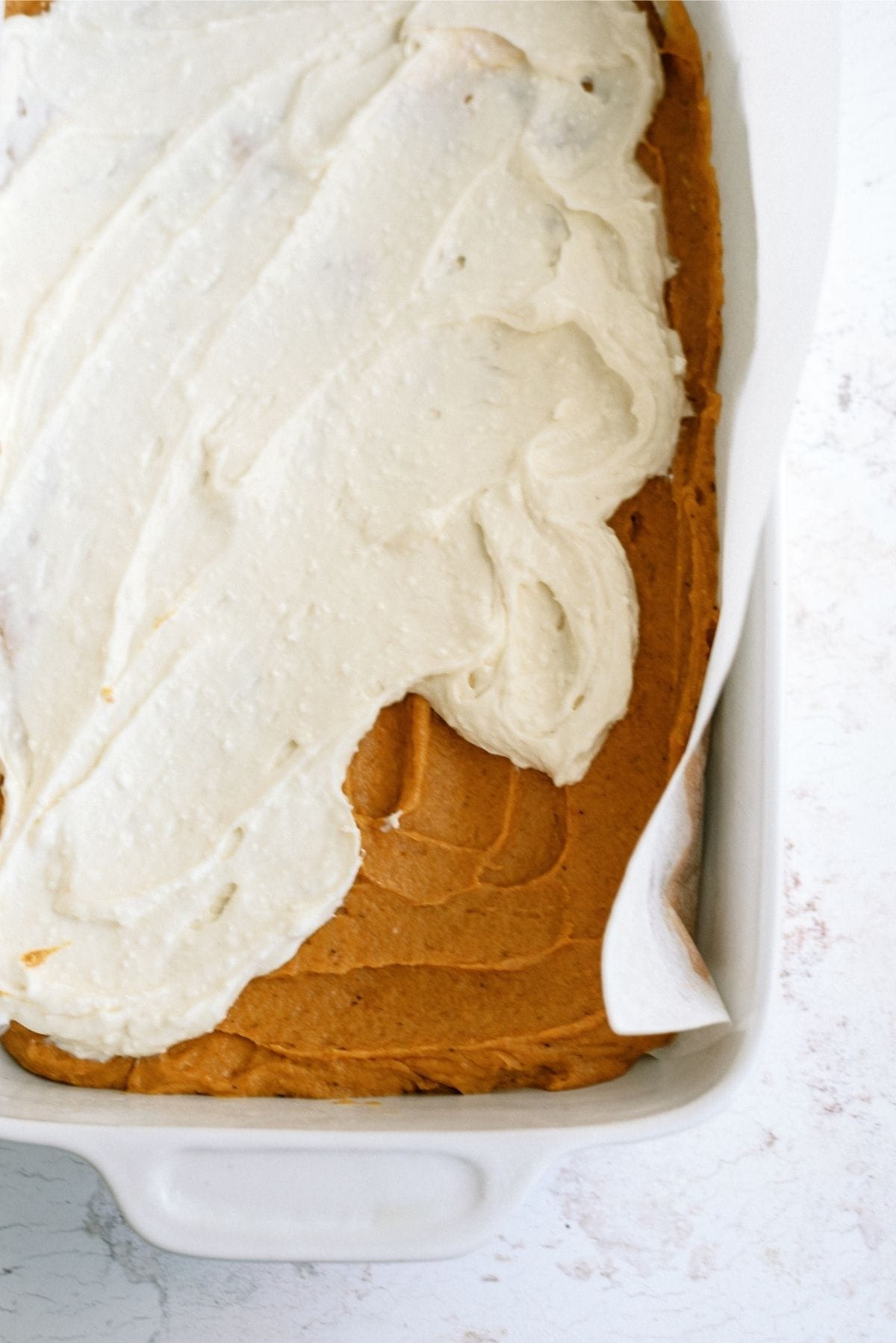 Cream cheese layer spread over bottom pumpkin layer