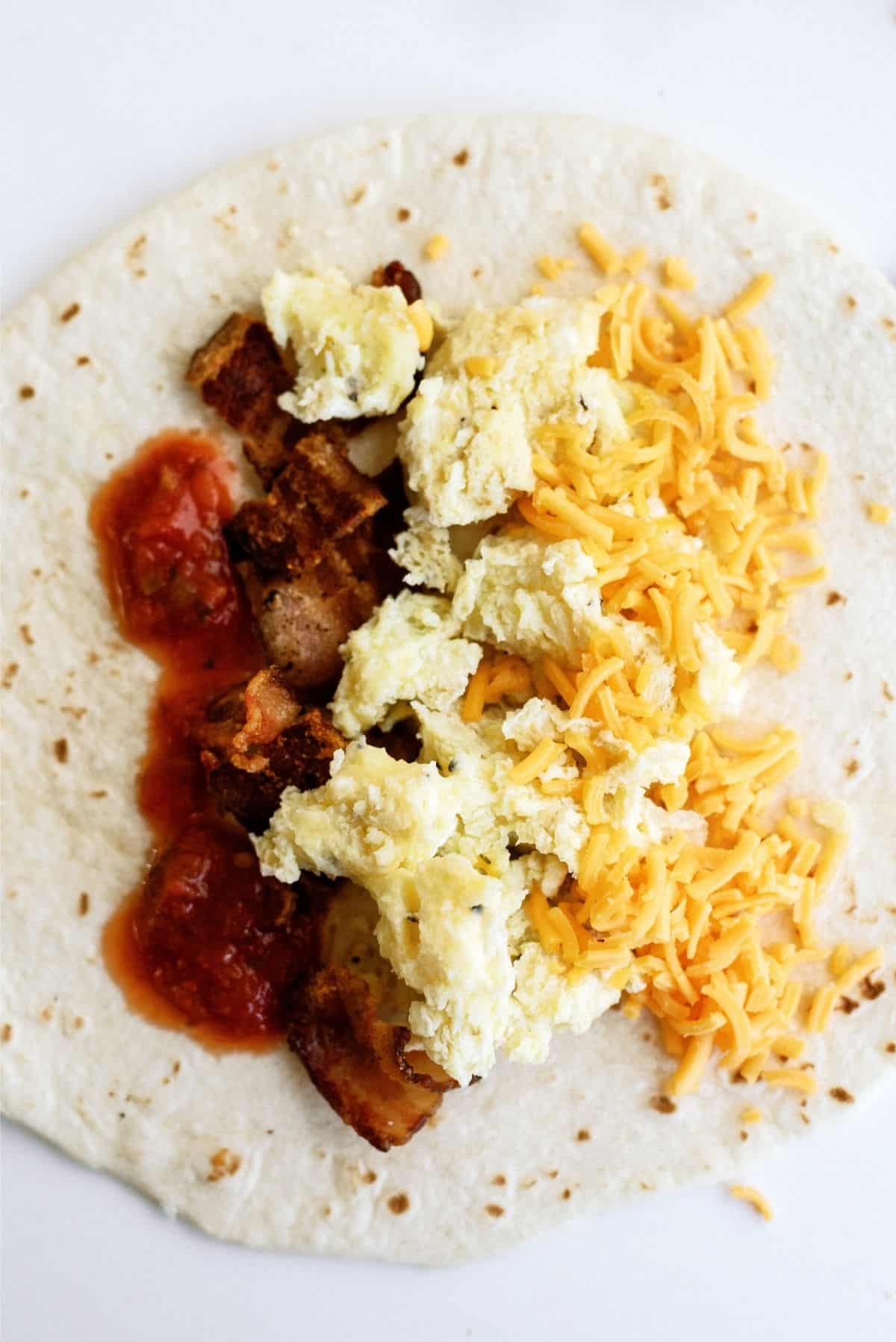 Open tortilla with egg mixture, cheese, bacon and salsa