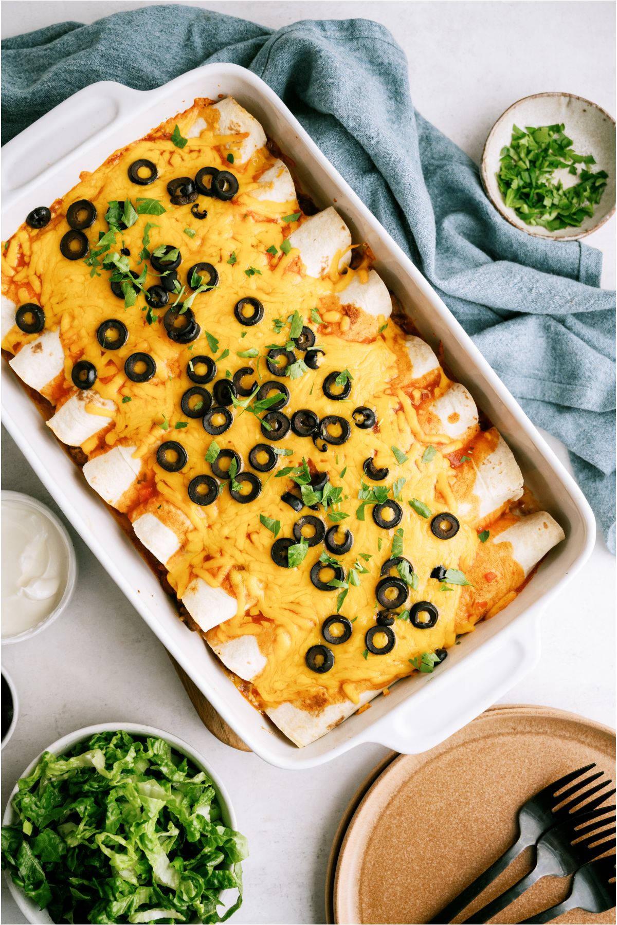 Top view of a pan of Hearty Ground Beef Enchiladas baked.