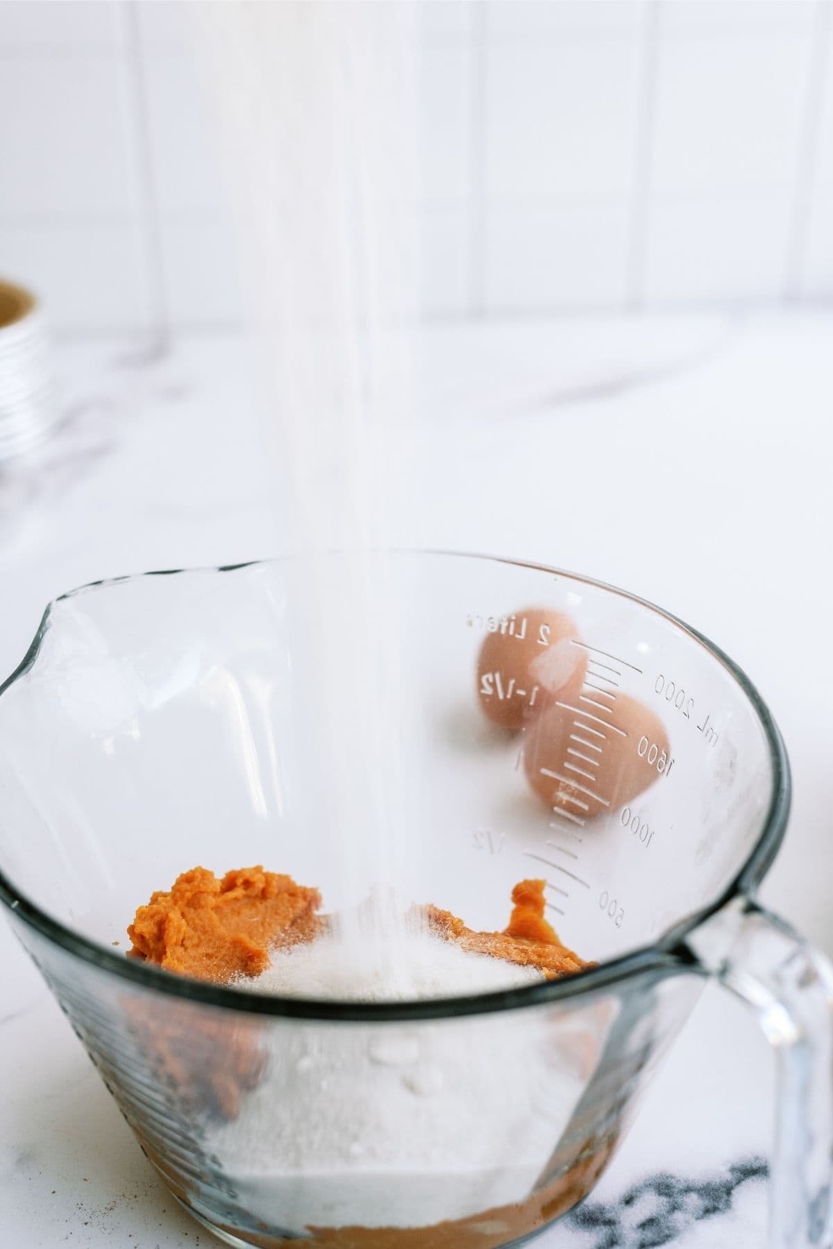 Pumpkin Pie mixture ingredients mixed together in a glass bowl