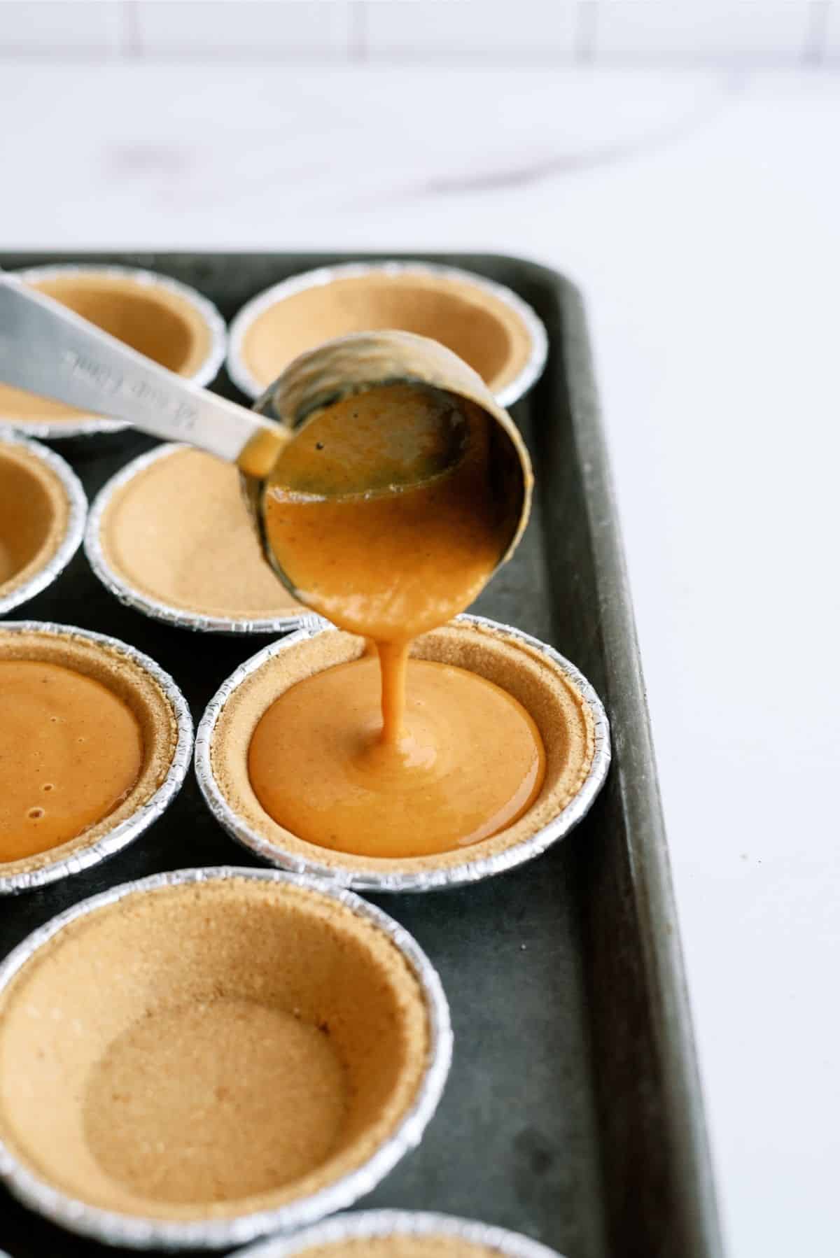 Filling pie crusts with 1/4 cup of pie filling