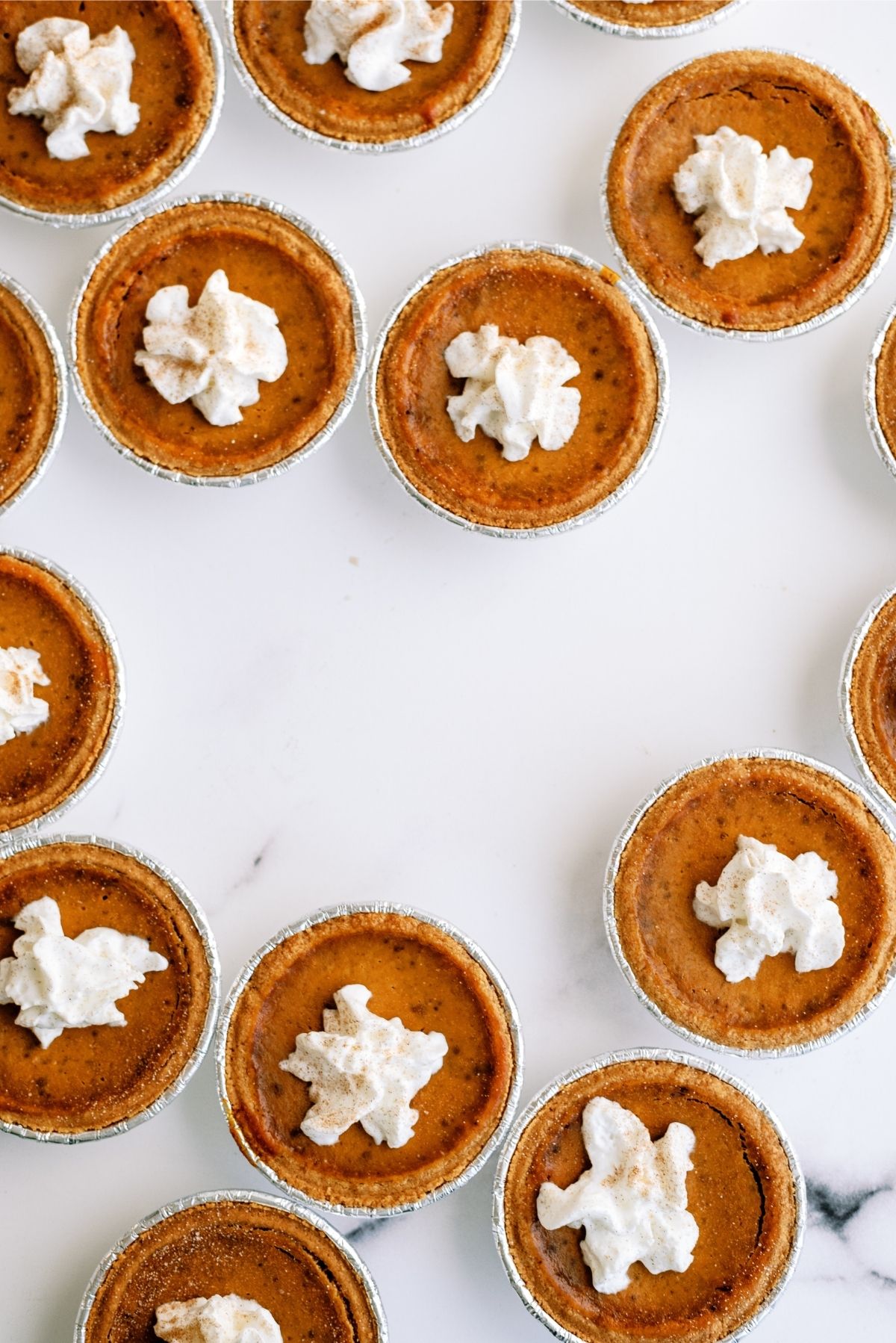 Mini Pumpkin Pies with Graham Cracker Crust on the counter