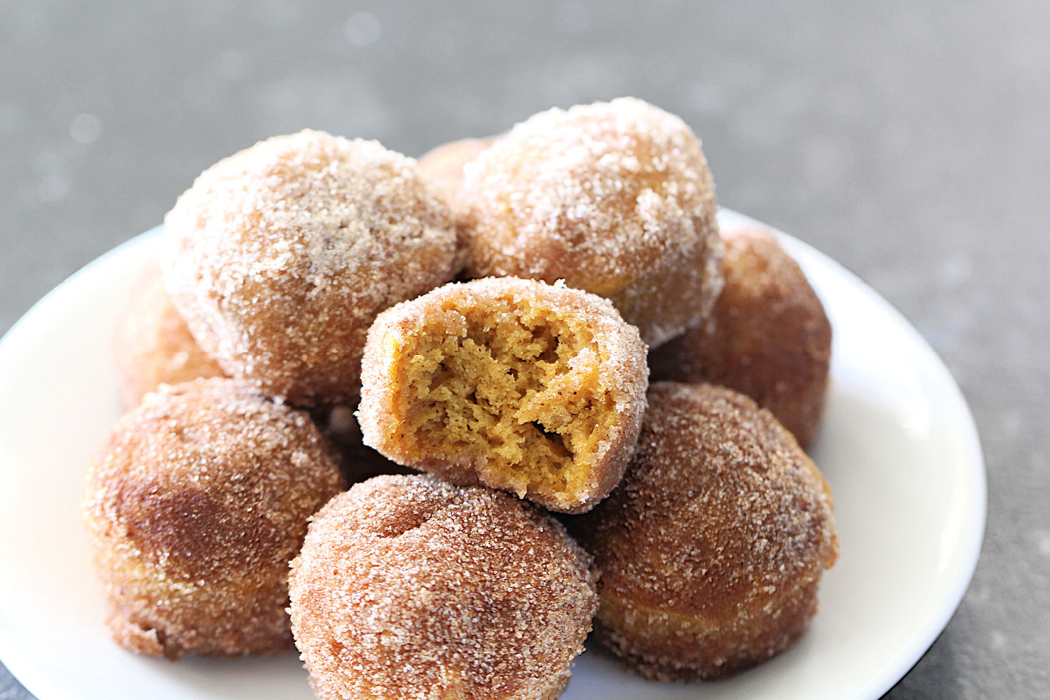 Baked Pumpkin Spice Donut Holes on a white plate
