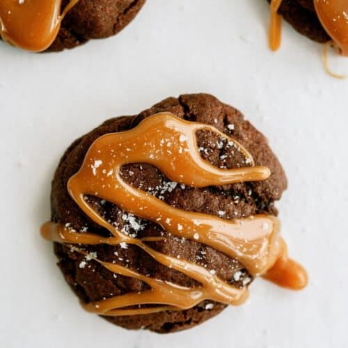 Top view of a Salted Caramel Chocolate Cookie. 2 more cookies in the background.