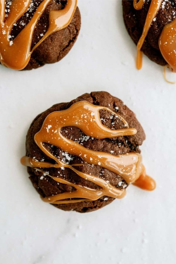 Top view of a Salted Caramel Chocolate Cookie. 2 more cookies in the background.