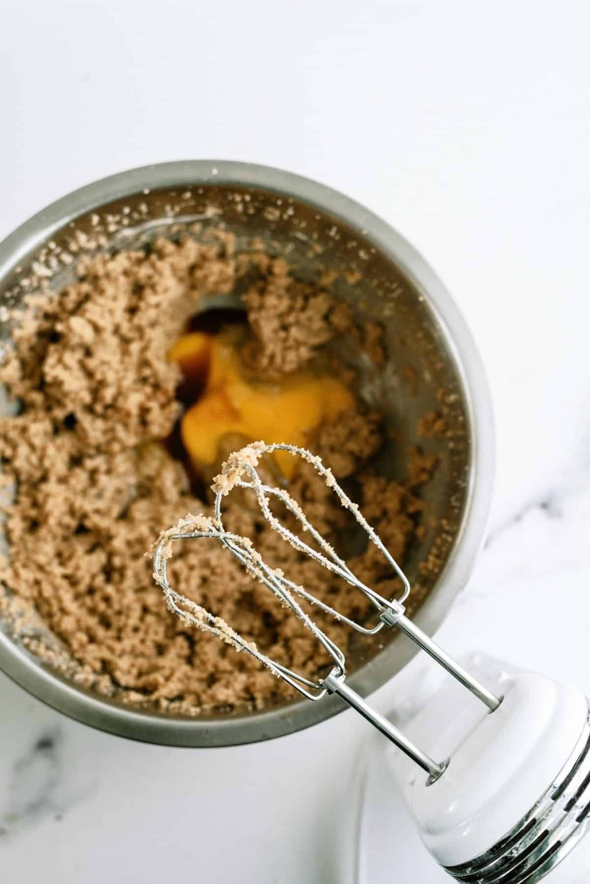 Cream together sugars, butter egg, and vanilla in a mixing bowl