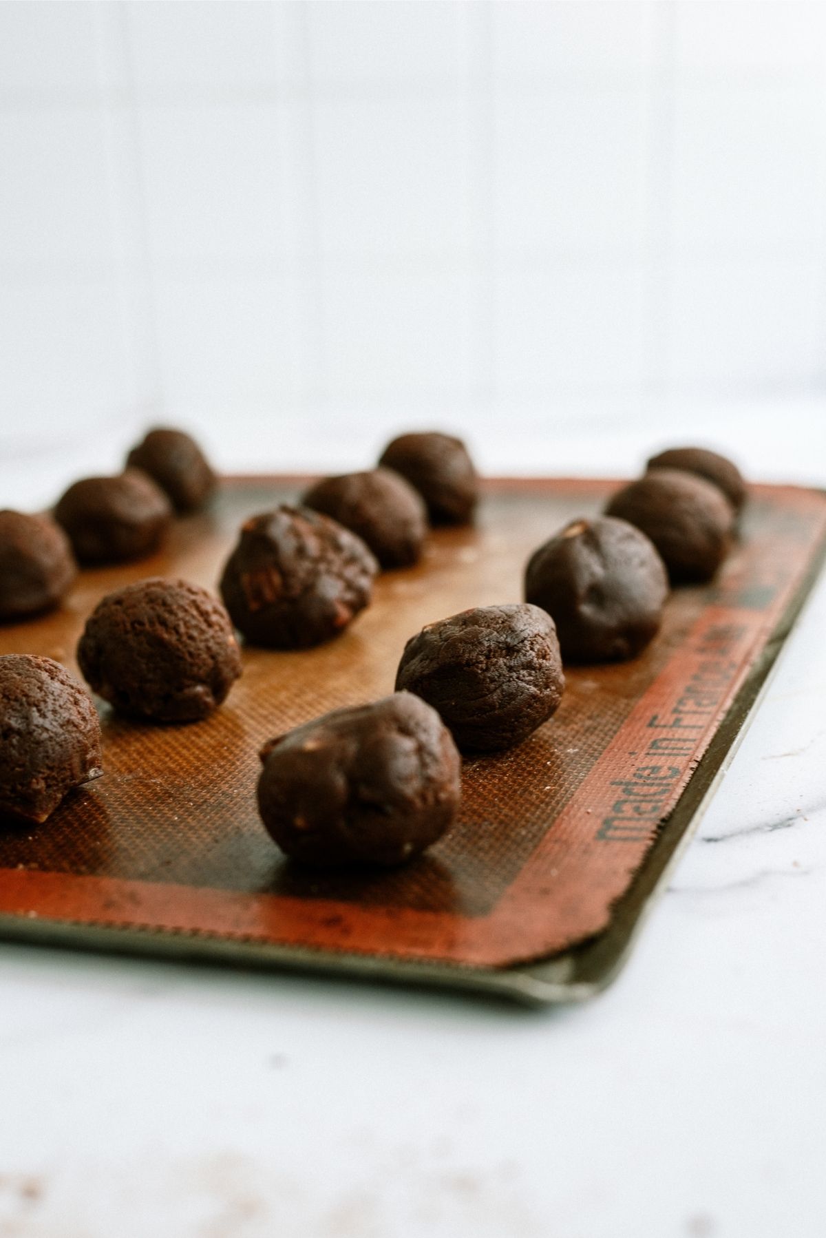 Salted Caramel Chocolate Cookie dough balls on a baking sheet