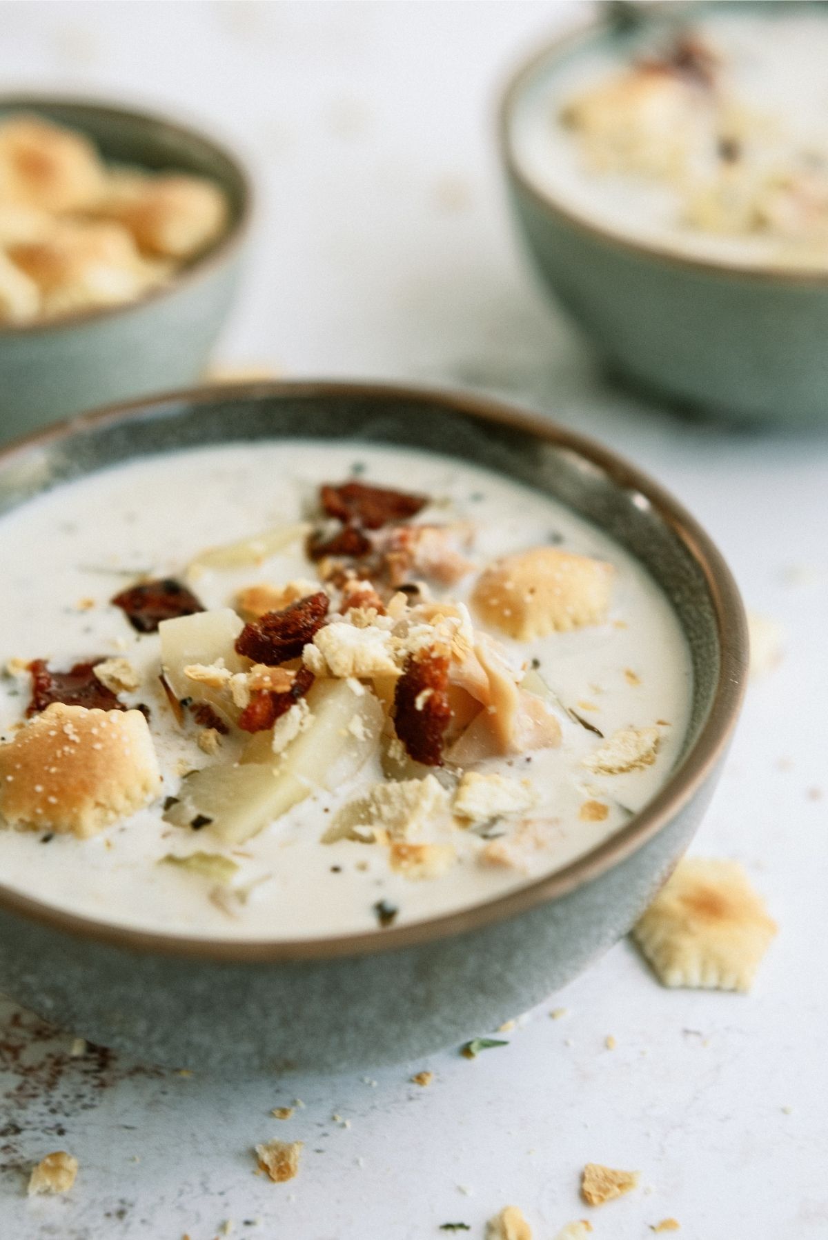 Slow Cooker New England Clam Chowder in a bowl with crackers