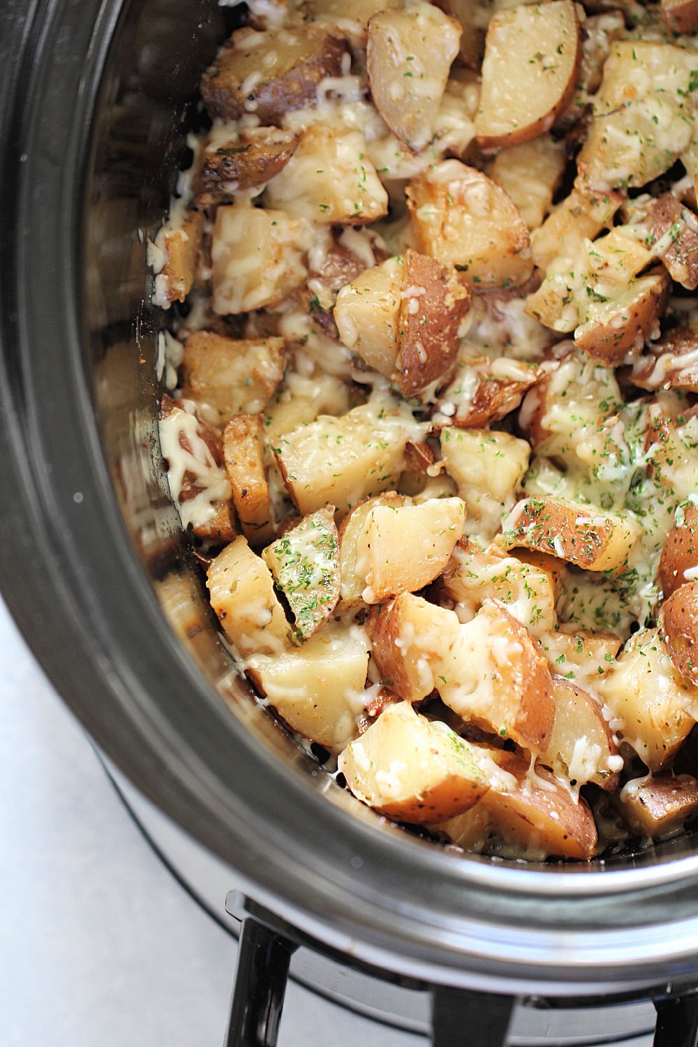 Slow Cooker Parmesan Ranch Potatoes
 in slow cooker topped with cheese
