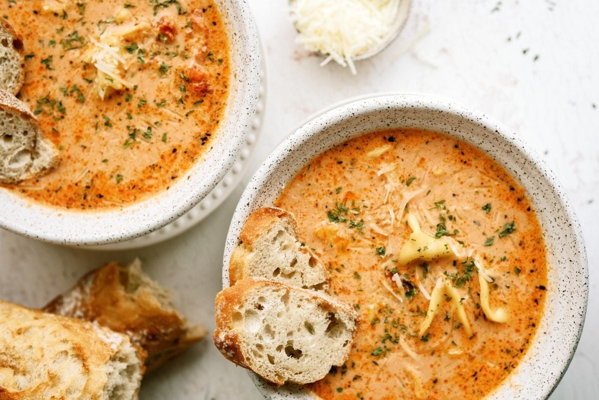 Tomato Tortellini Soup in two bowls with a side of bread