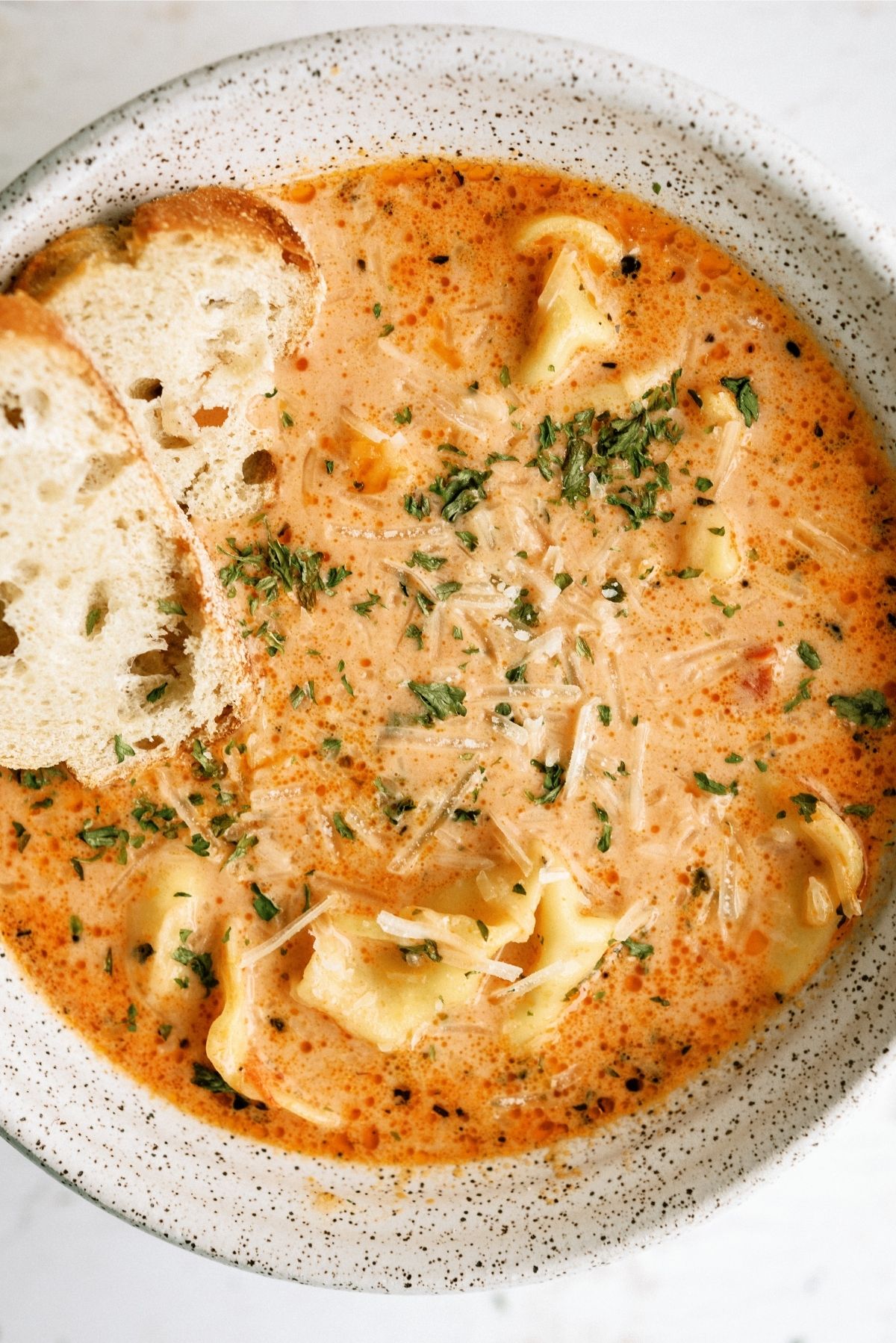 Tomato Tortellini Soup in a bowl served with slices of bread