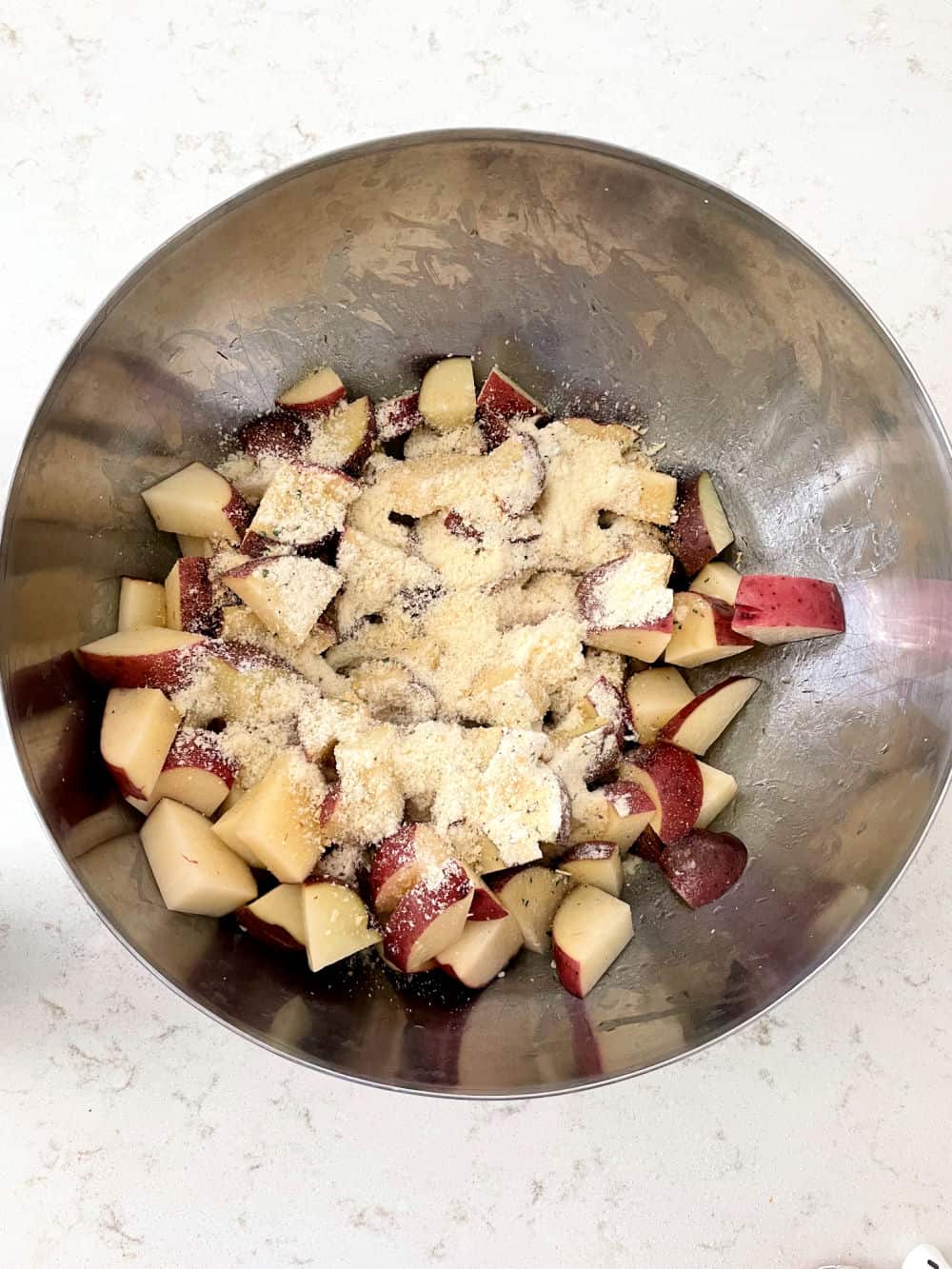 Cut potatoes in a large bowl with seasonings, olive oil and cheese