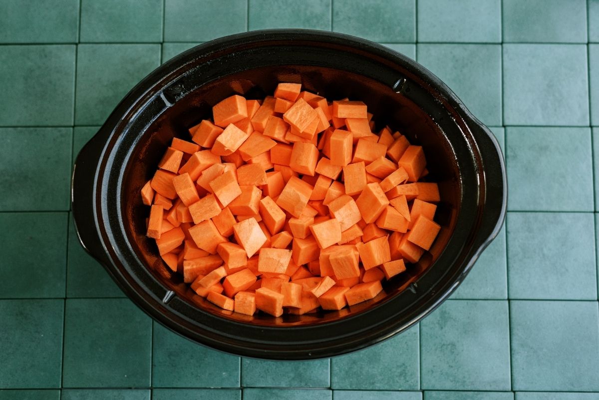 Peeled and diced sweet potatoes inside slow cooker