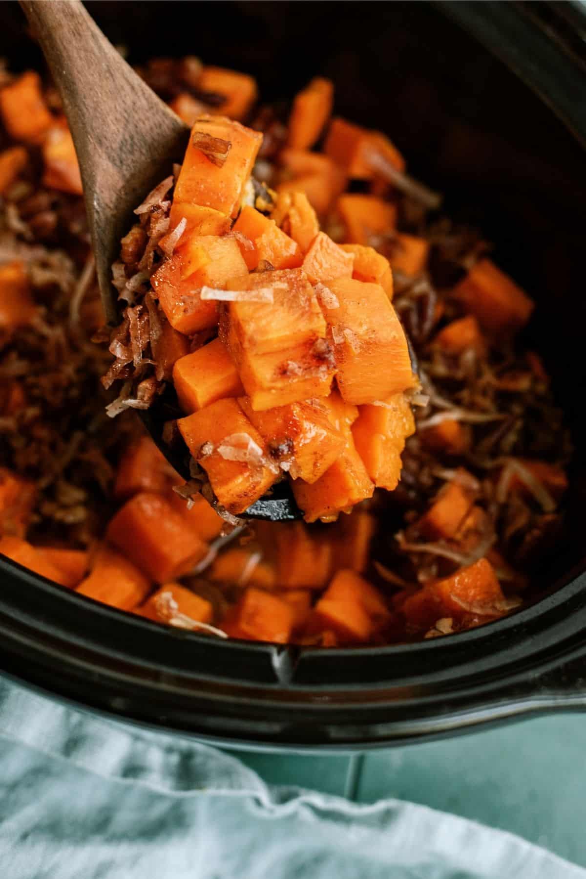 Wooden Spoon with a scoop of Coconut Pecan Sweet Potatoes