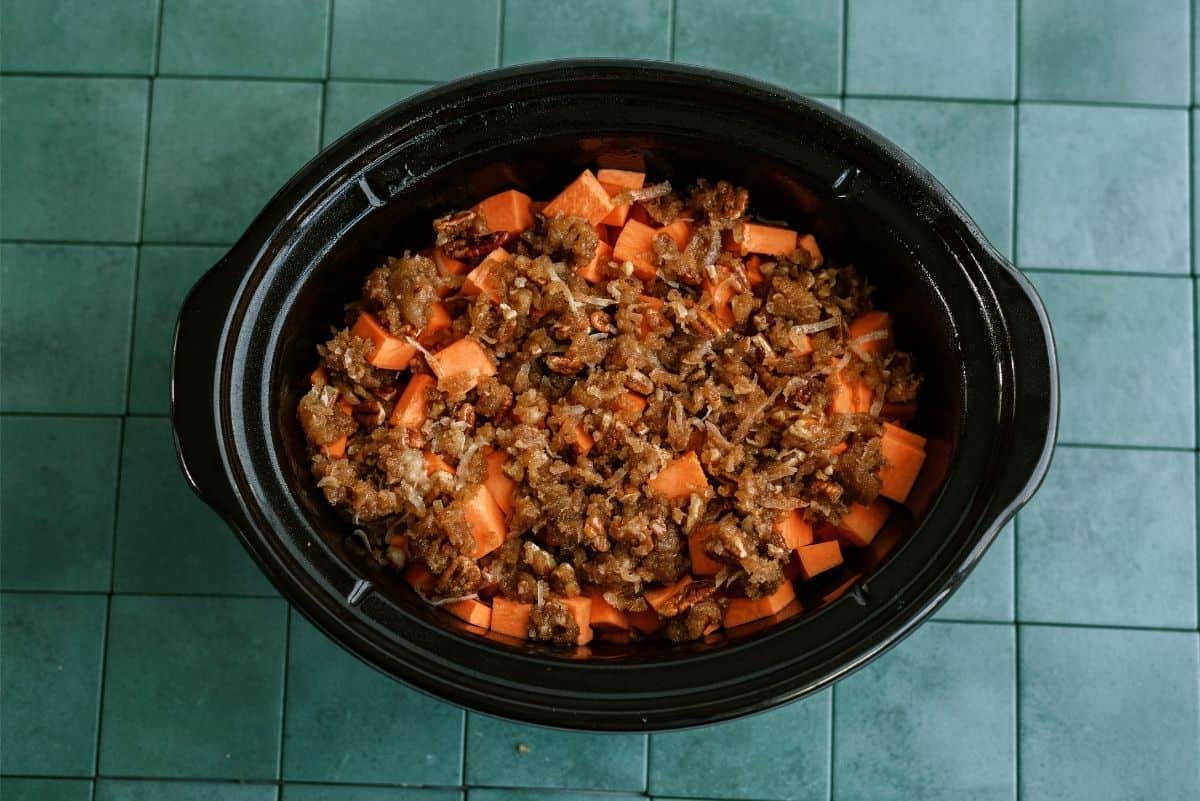 Coconut Mixture on top of sweet potatoes in the slow cooker