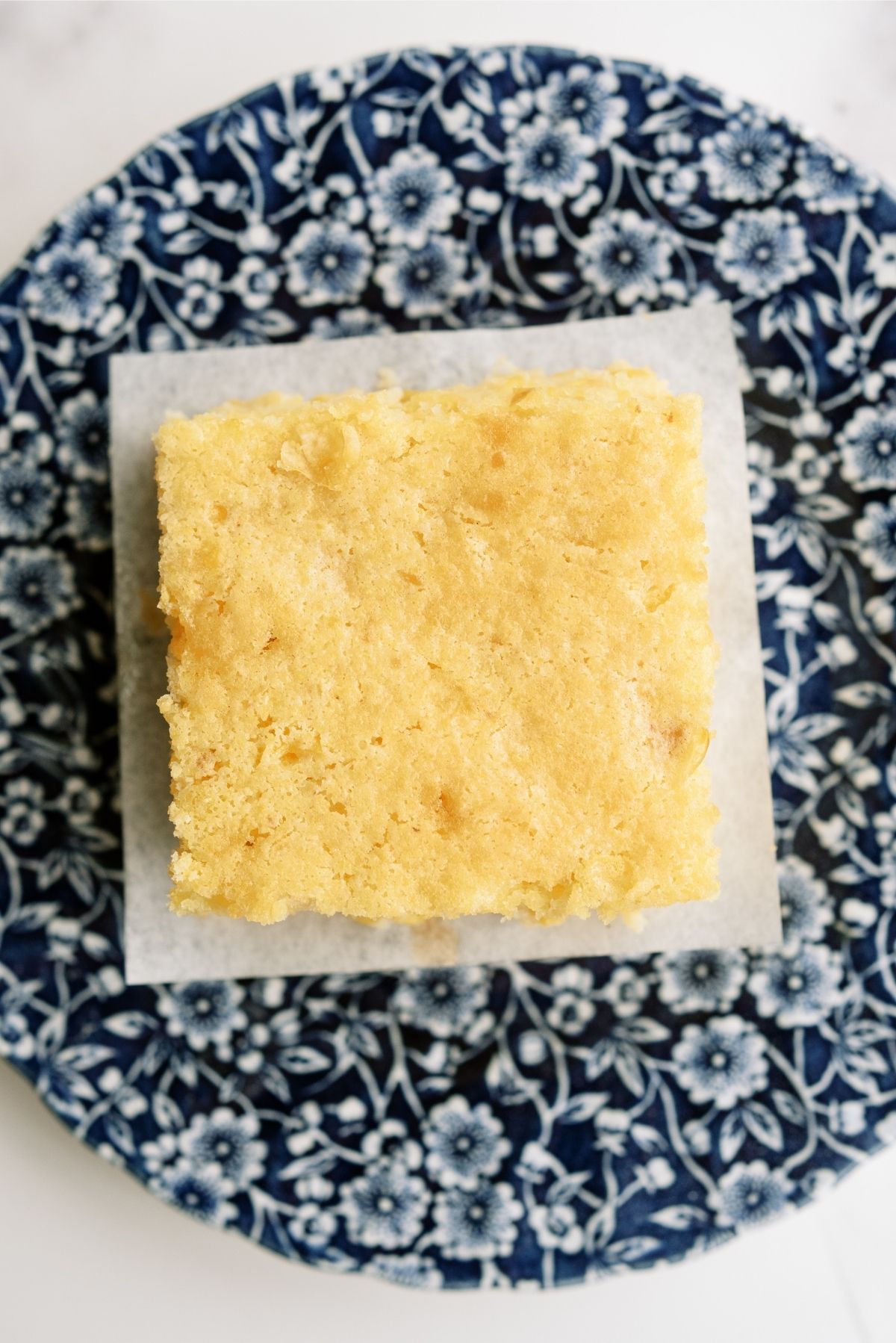 One slice of Corn Pudding Casserole on a blue plate
