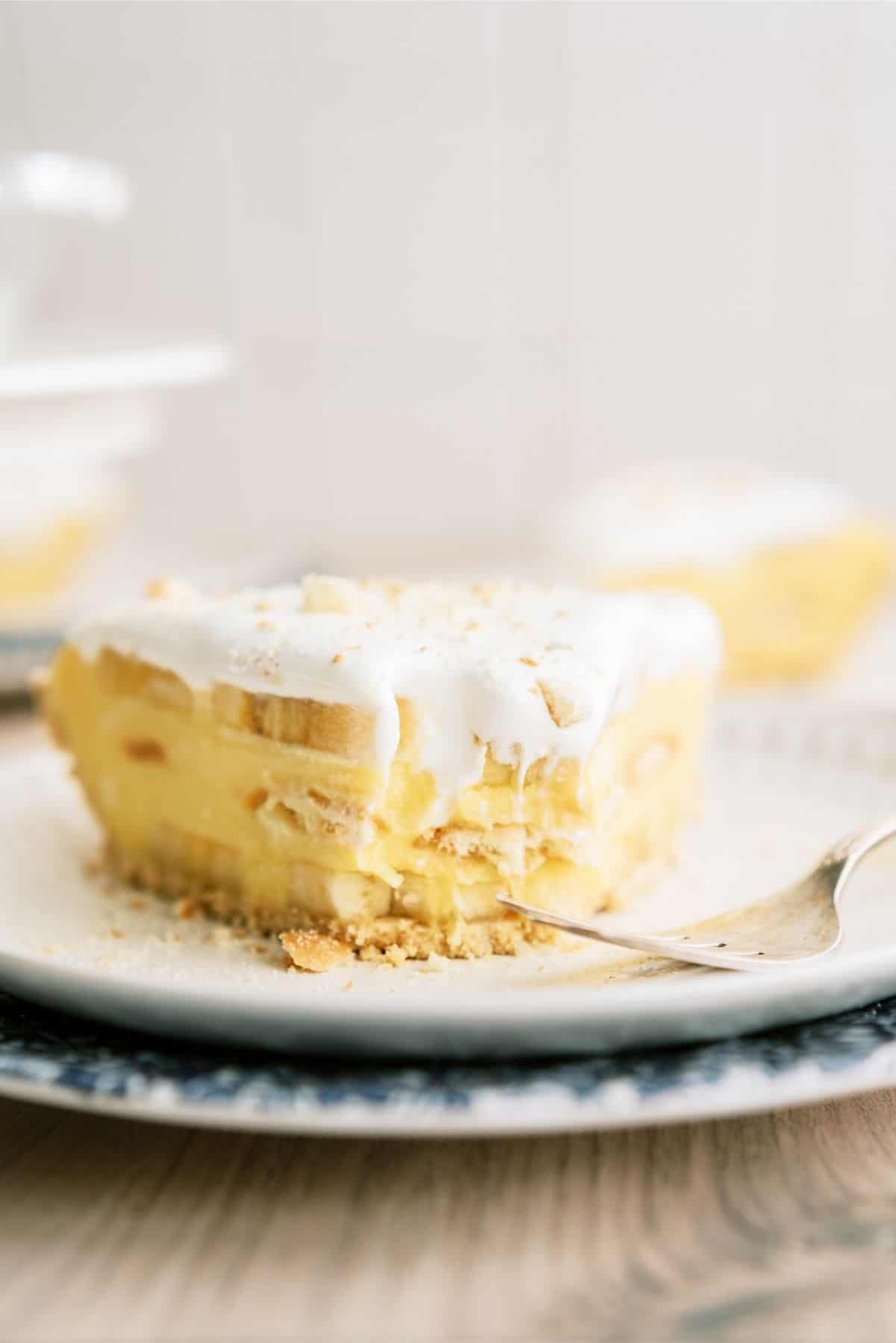 A Slice of Easy Banana Cream Pie on a plate with a fork