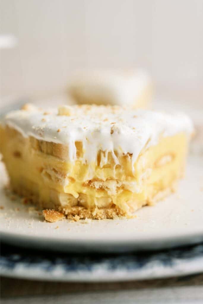 Front view of a slice of Banana Cream Pie with a bite missing in the front.