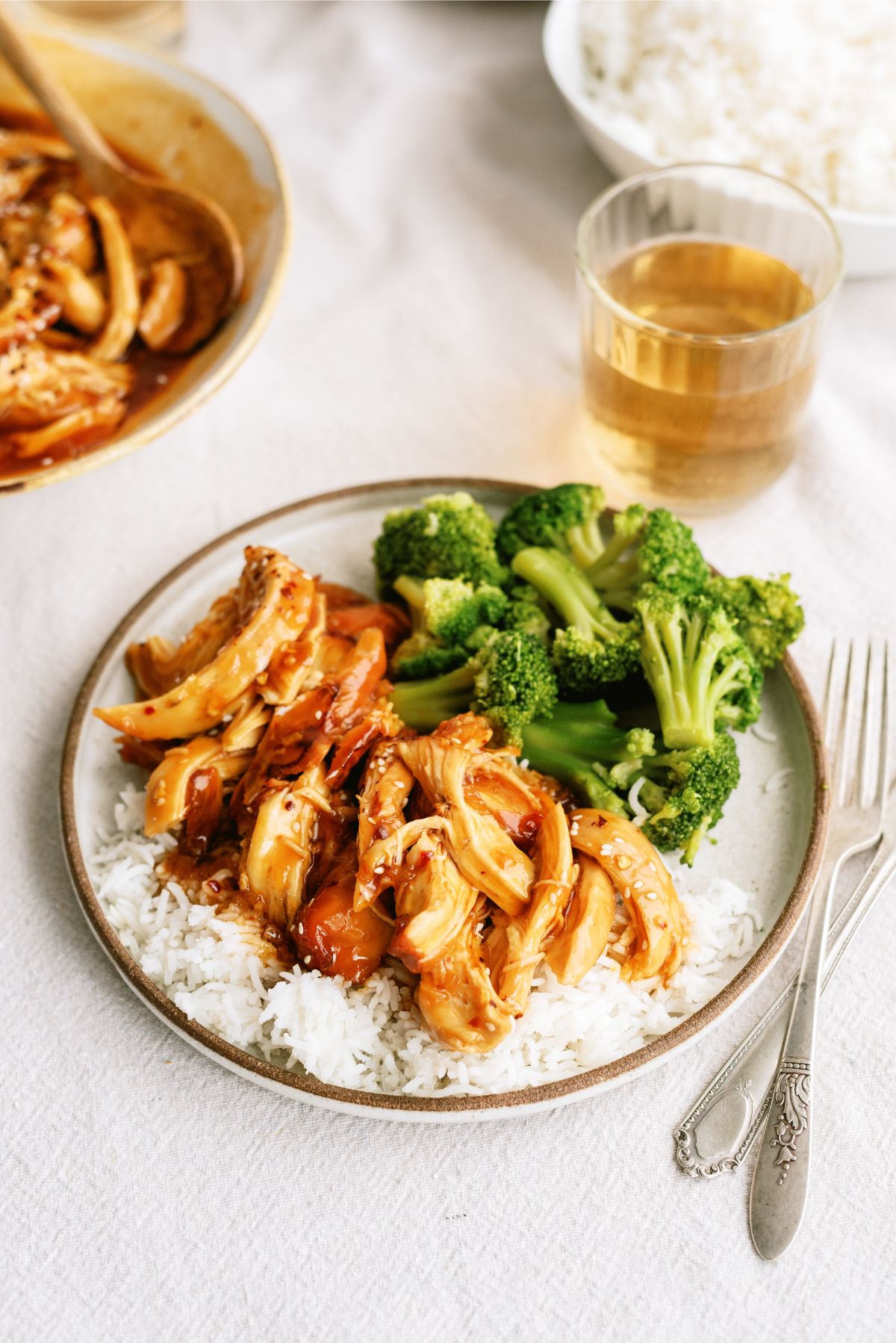 Instant Pot Honey Sesame Chicken on a plate over rice with broccoli