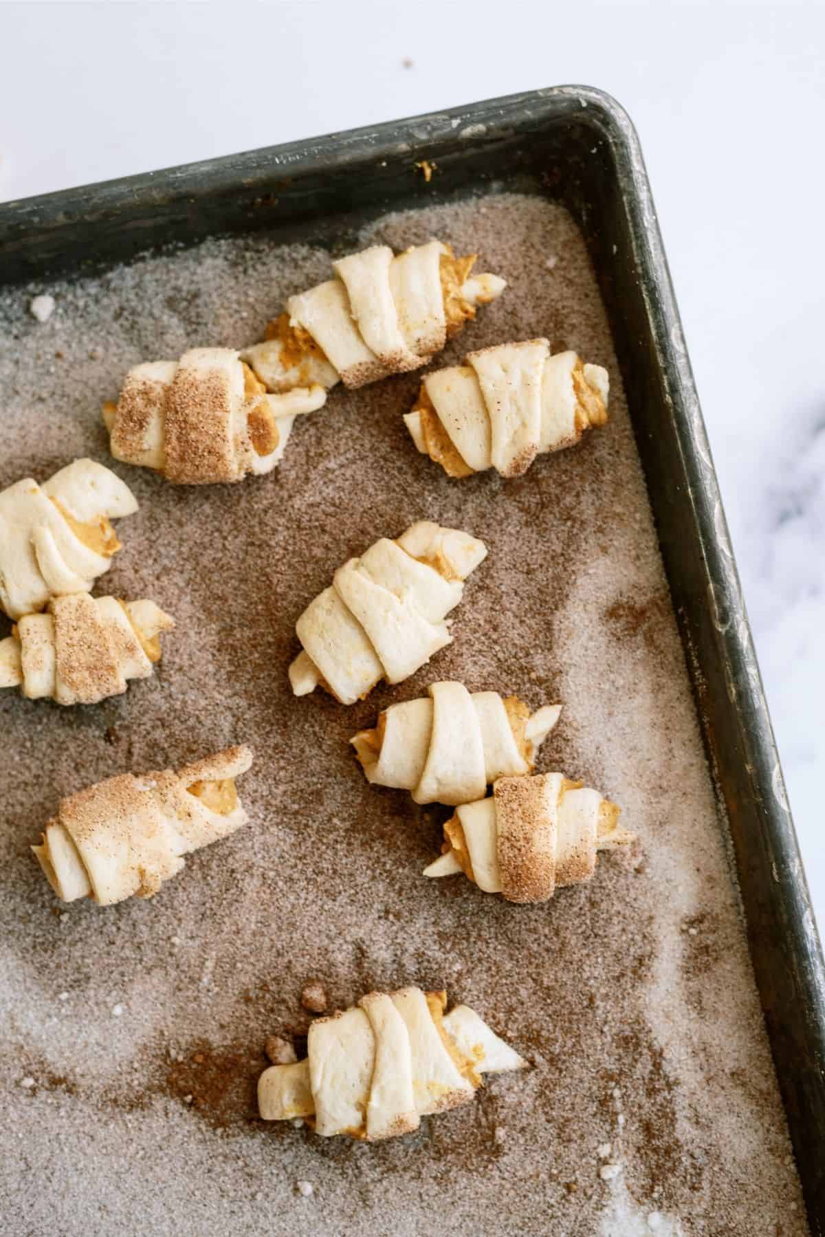 Mini Pumpkin Pie Crescents rolled in cinnamon and sugar mixture