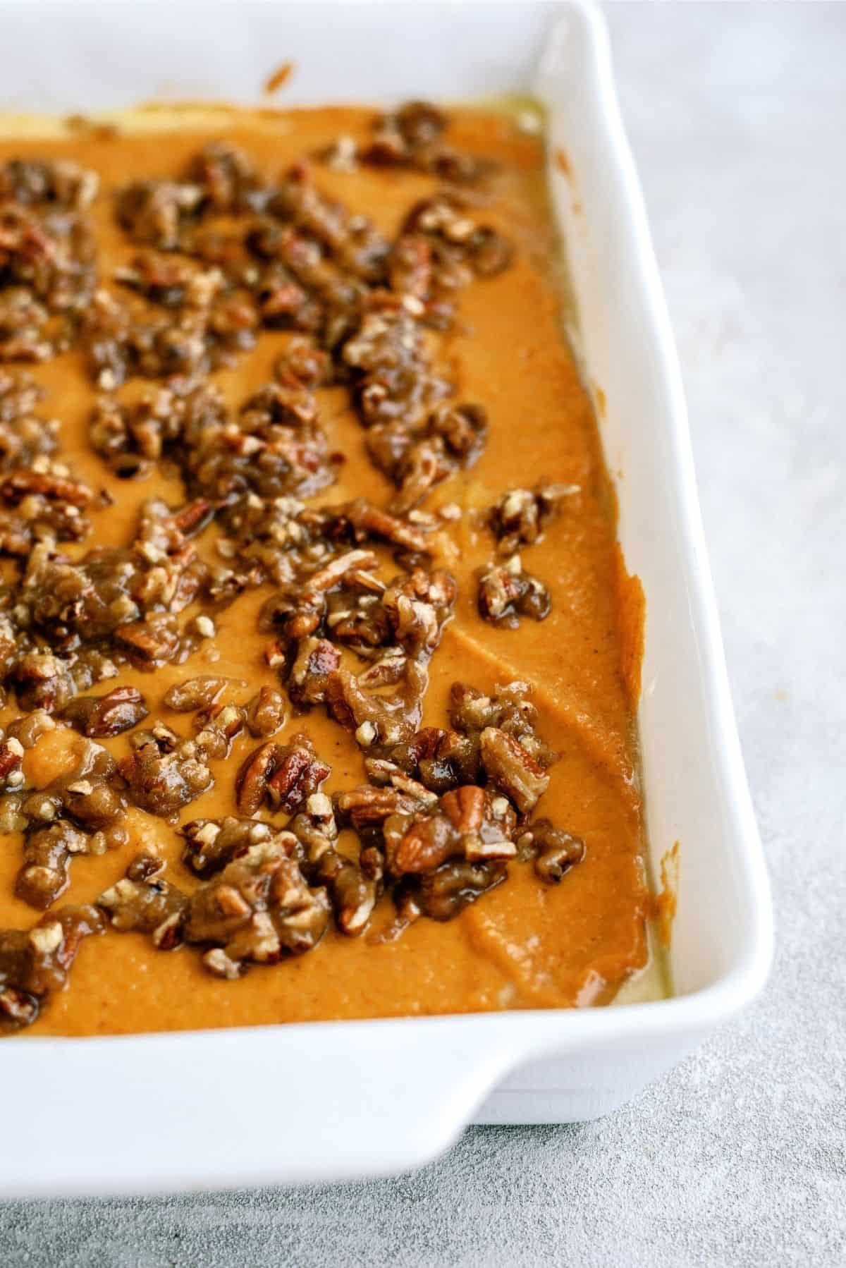 Pecan mixture sprinkled on top of pumpkin layer