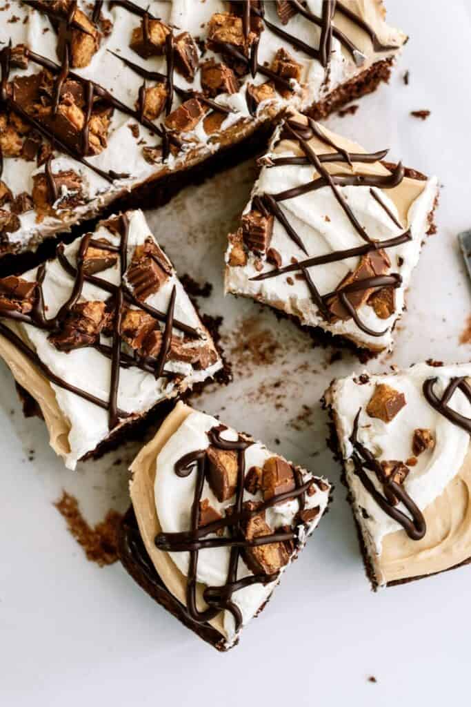 Reese’s Peanut Butter Poke Cake cut into squares.