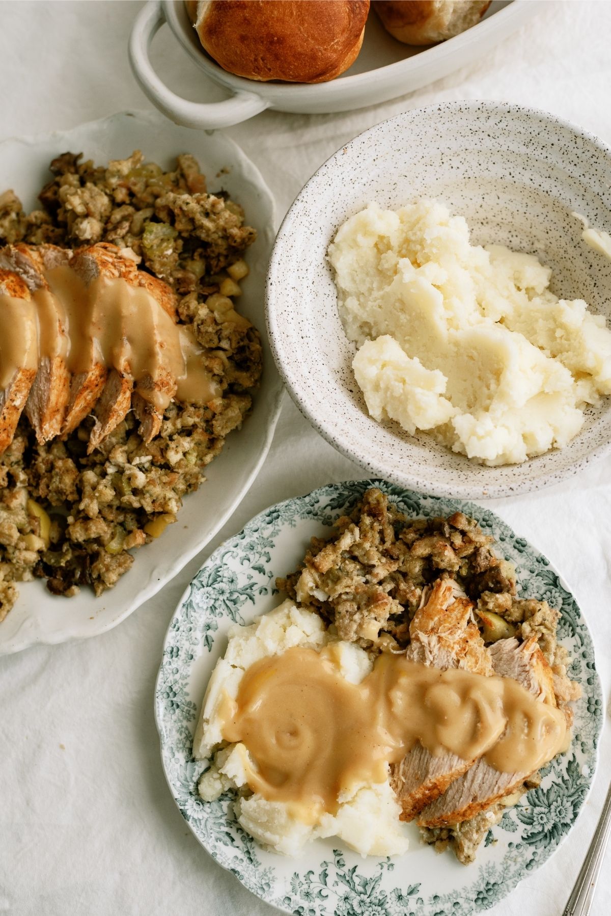 Slow Cooker Turkey and Stuffing with mashed potatoes and gravy on a plate