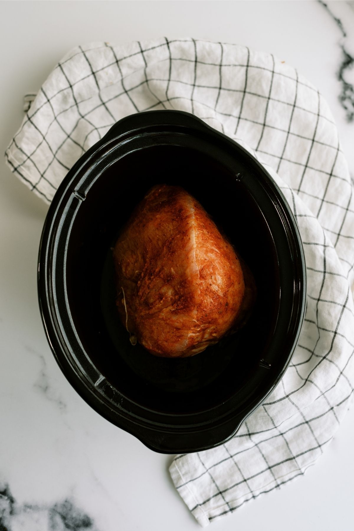 Turkey breast placed in the bottom of slow cooker insert