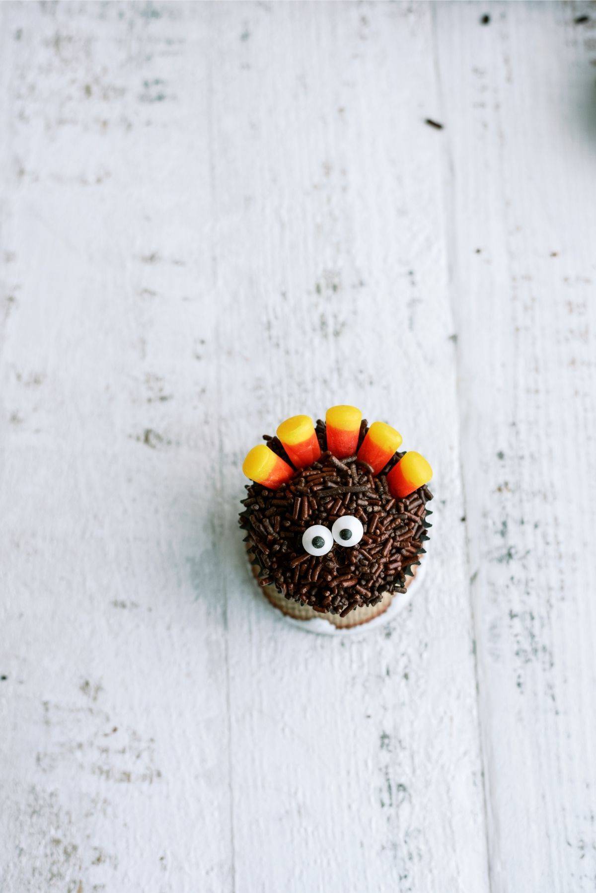 Two candy eye balls added to the chocolate cupcake