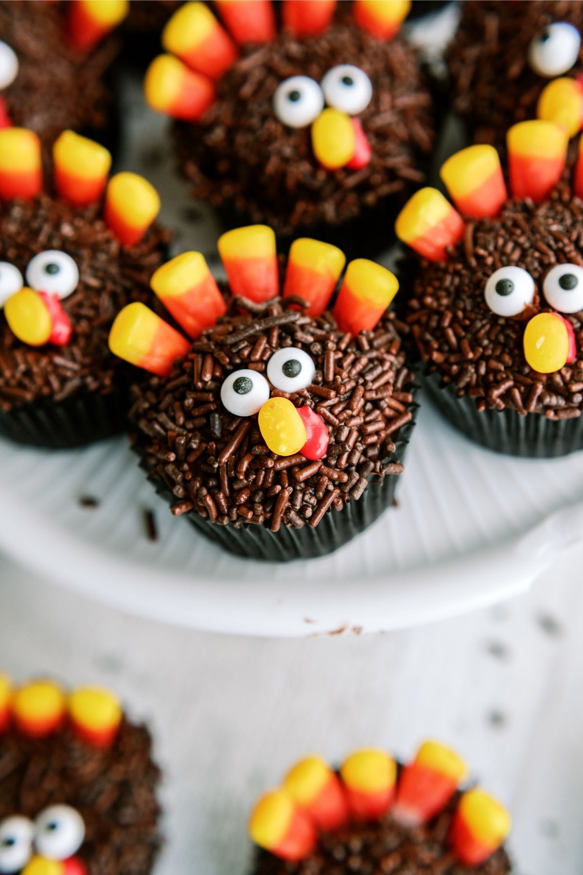 Thanksgiving Turkey Cupcakes on a cake platter and on the counter