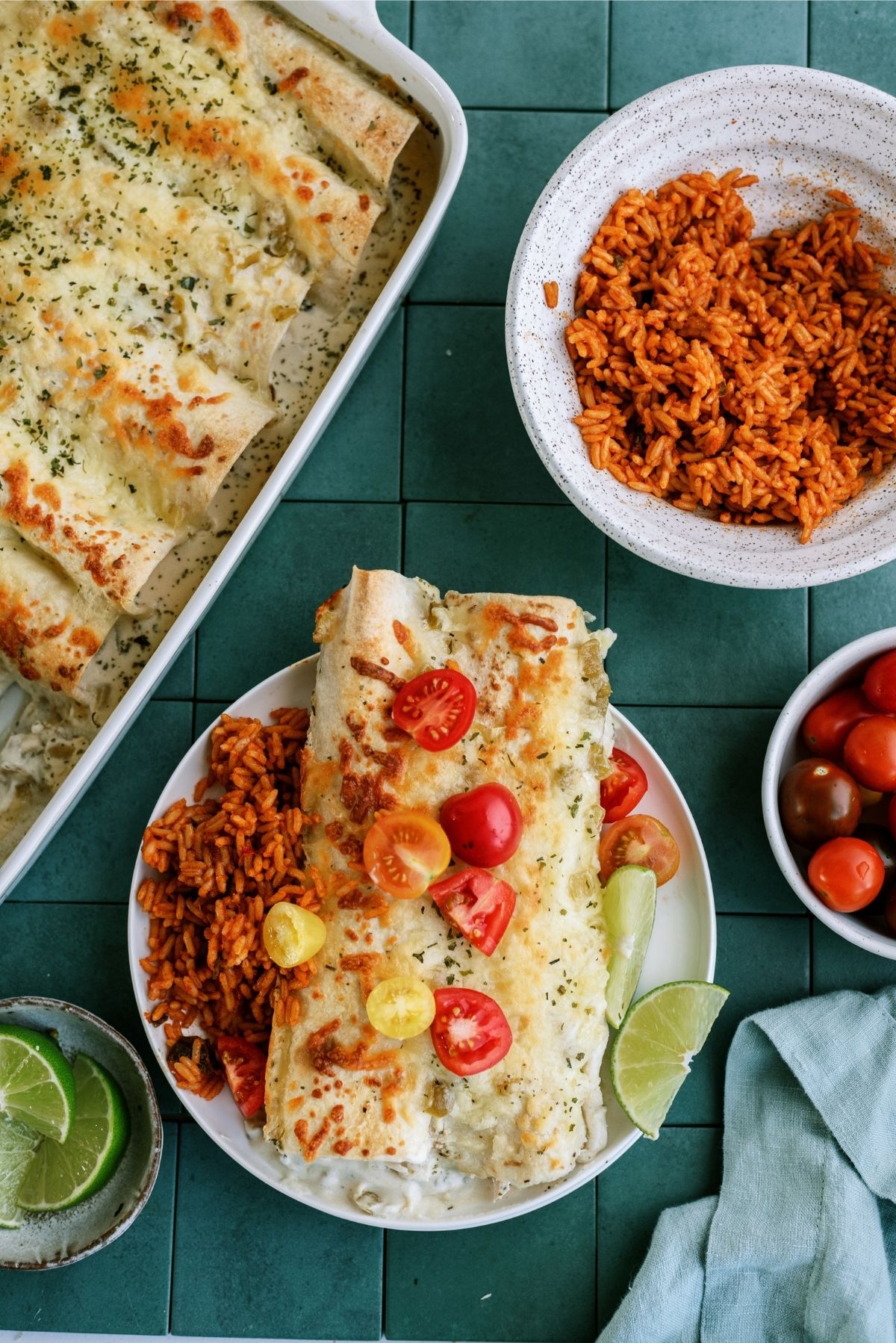 Turkey Enchiladas on a plate served with toppings and rice on the side.