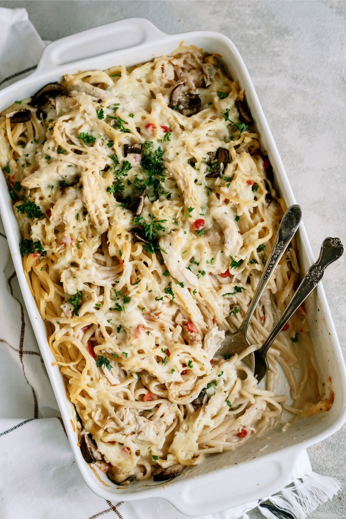 Baked Chicken Tetrazzini Casserole in baking dish with serving utensils