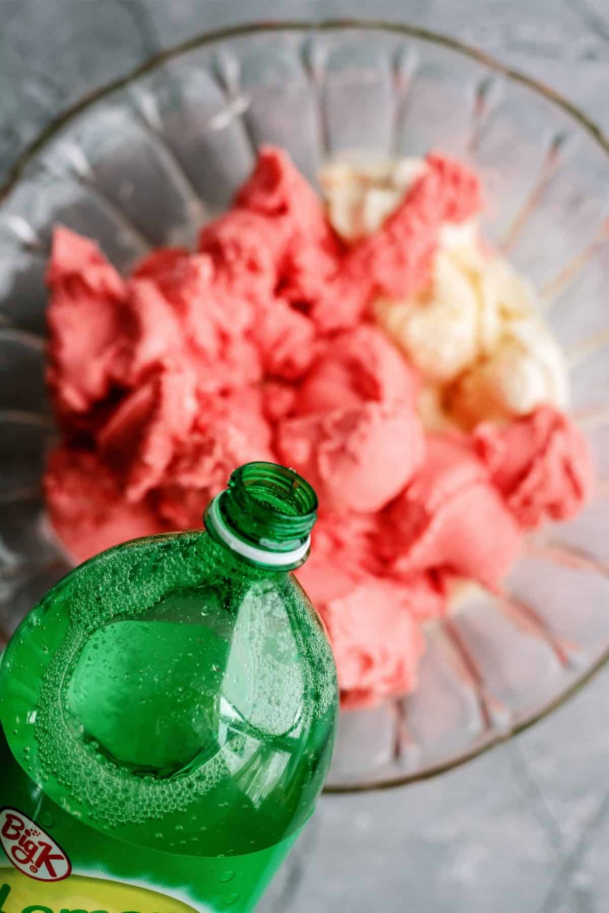 Pour lemon lime soda in the punch bowl on top of the ice cream