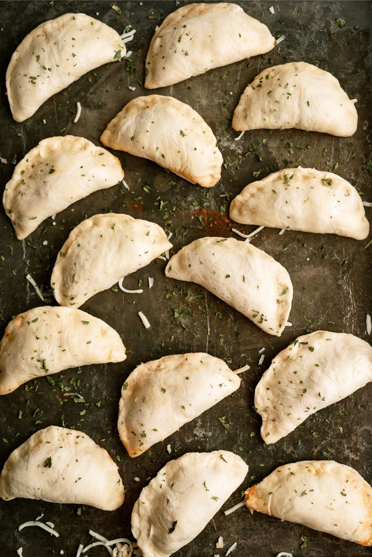 Pizza Pockets unbaked and sealed on a baking sheet