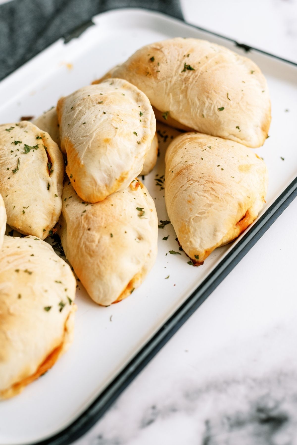 Homemade Pizza Pockets baked on a serving plate
