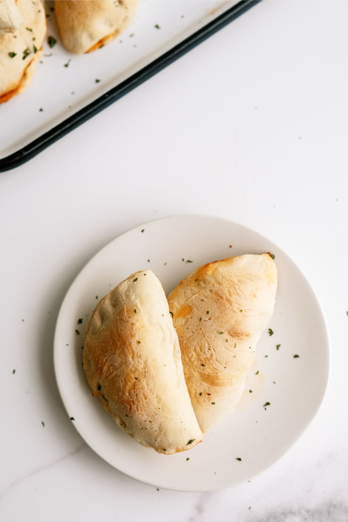 2 Homemade Pizza Pockets on a white plate