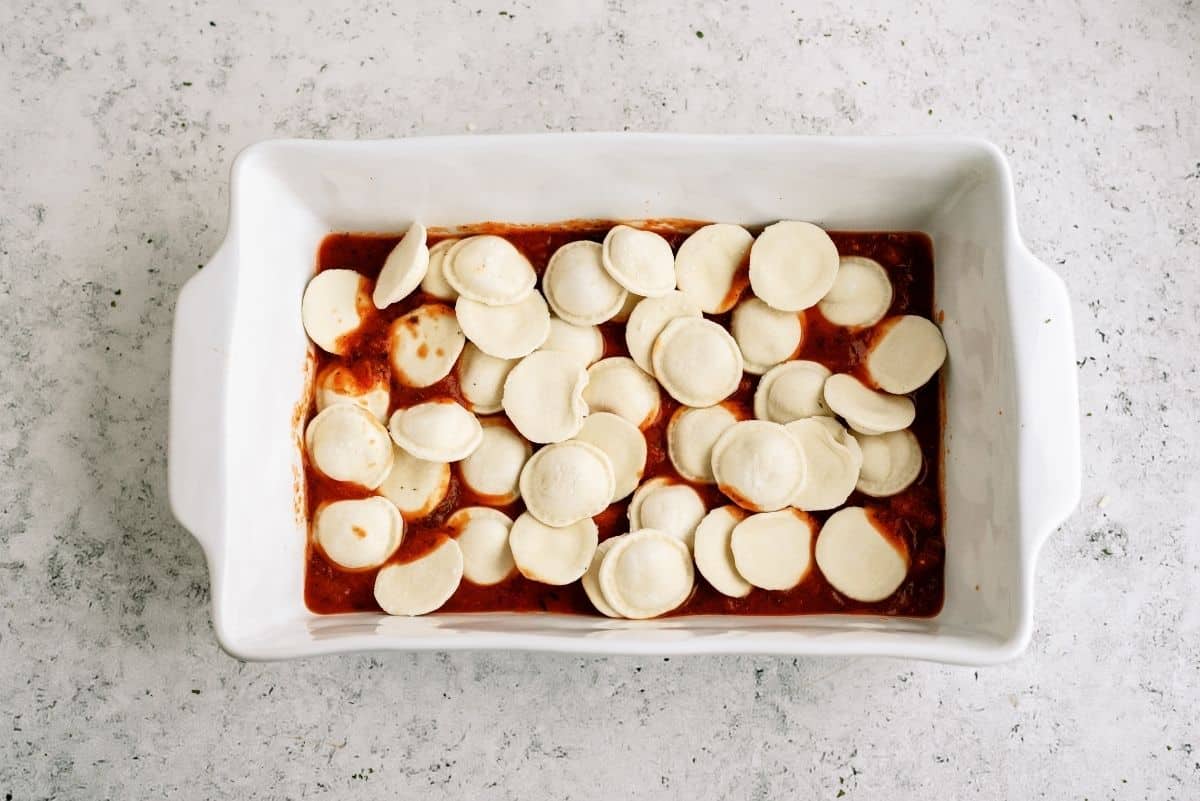 1/2 the frozen ravioli on top of the sauce layer