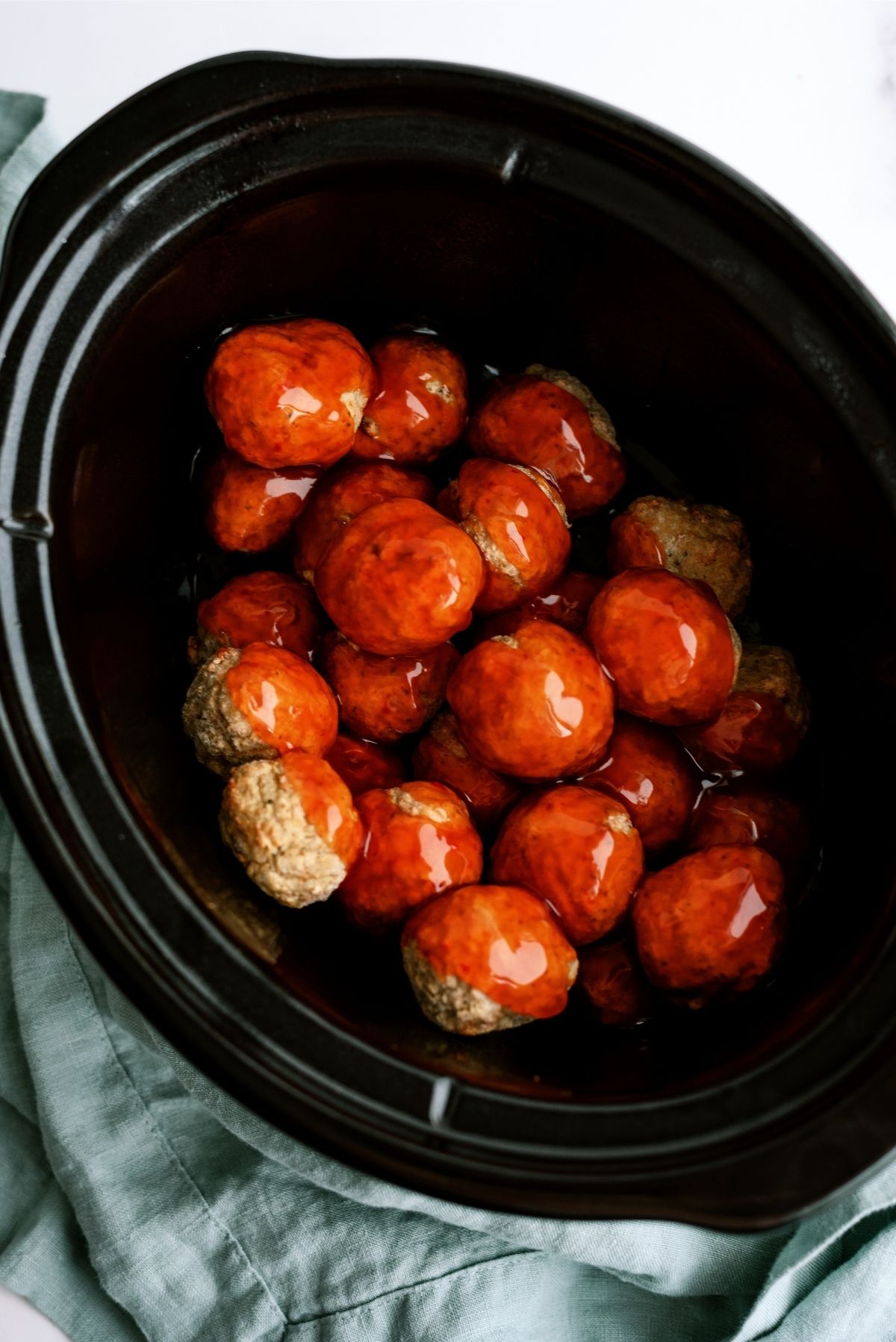 Slow cooker with meatballs and sweet and sour sauce