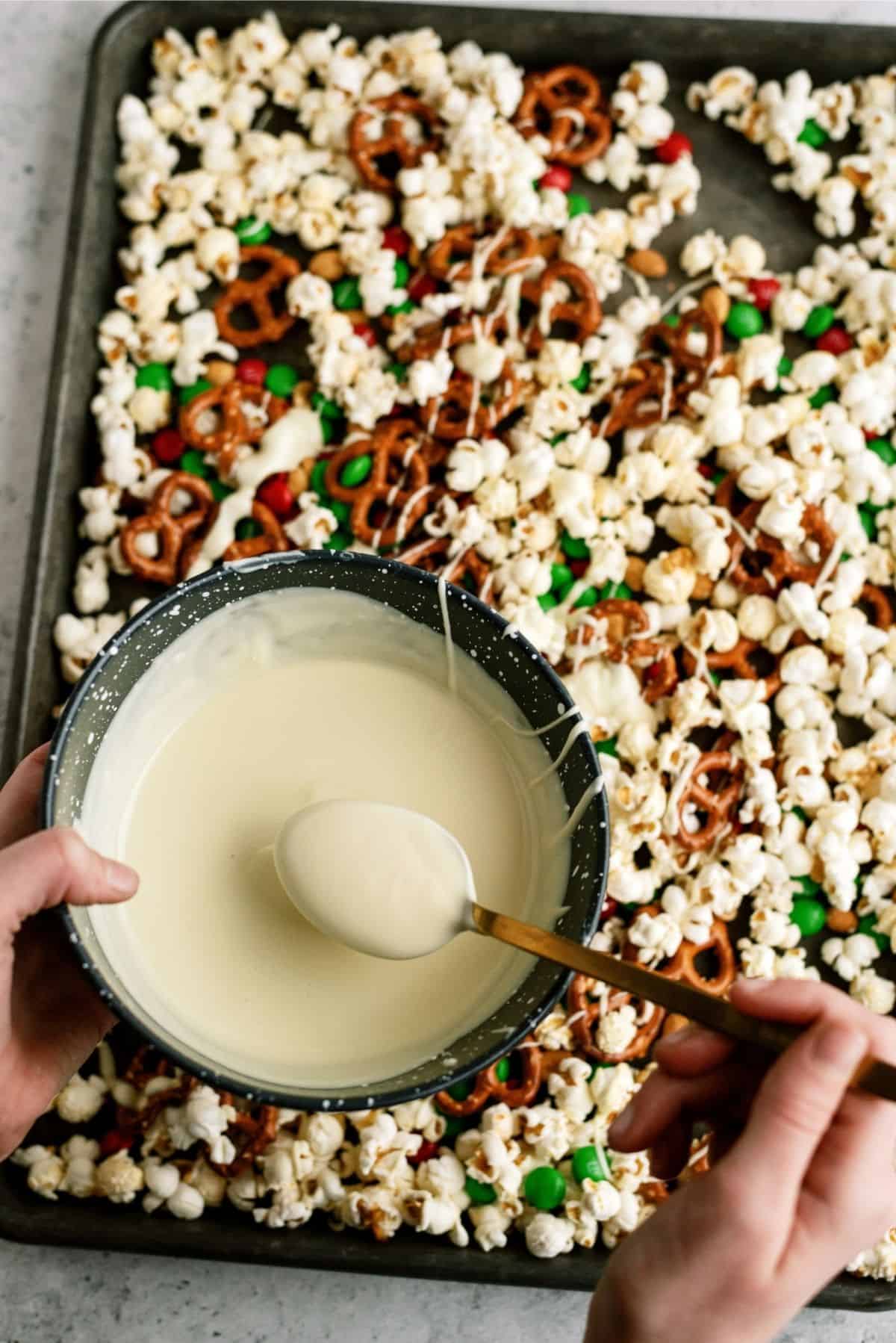 Melted white chocolate mixture in bowl to drizzle over popcorn mixture