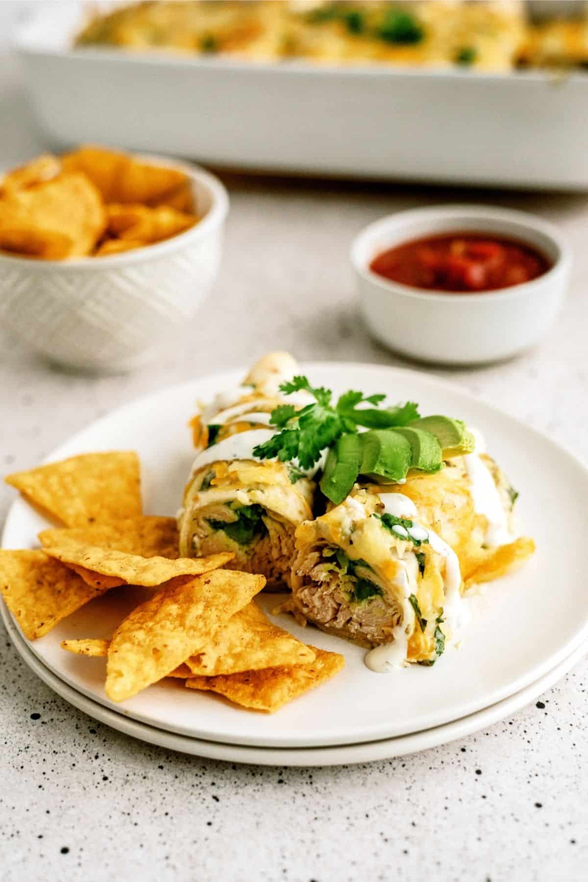 Avocado Chicken Enchiladas on a plate with tortilla chips