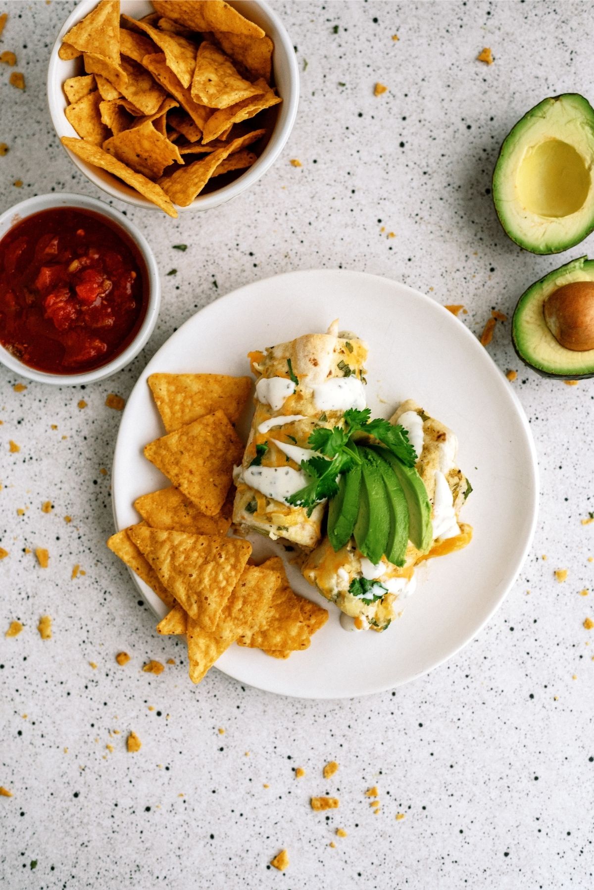 Avocado Chicken Enchiladas on a plate with tortilla chips