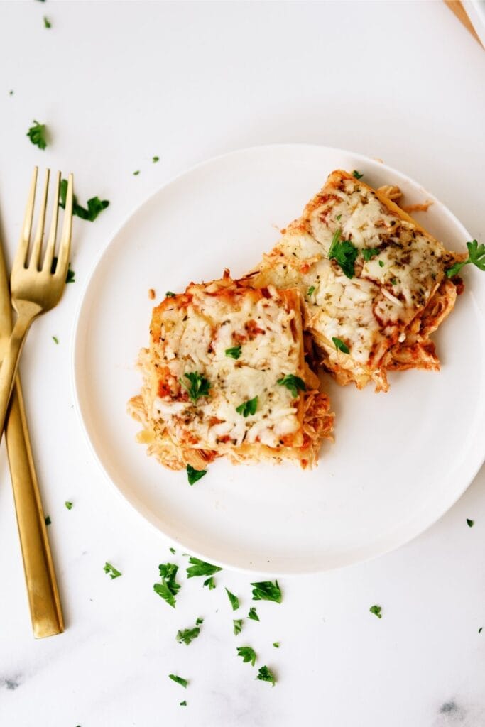 Top view of two slices of Creamy Chicken Lasagna on a white plate.