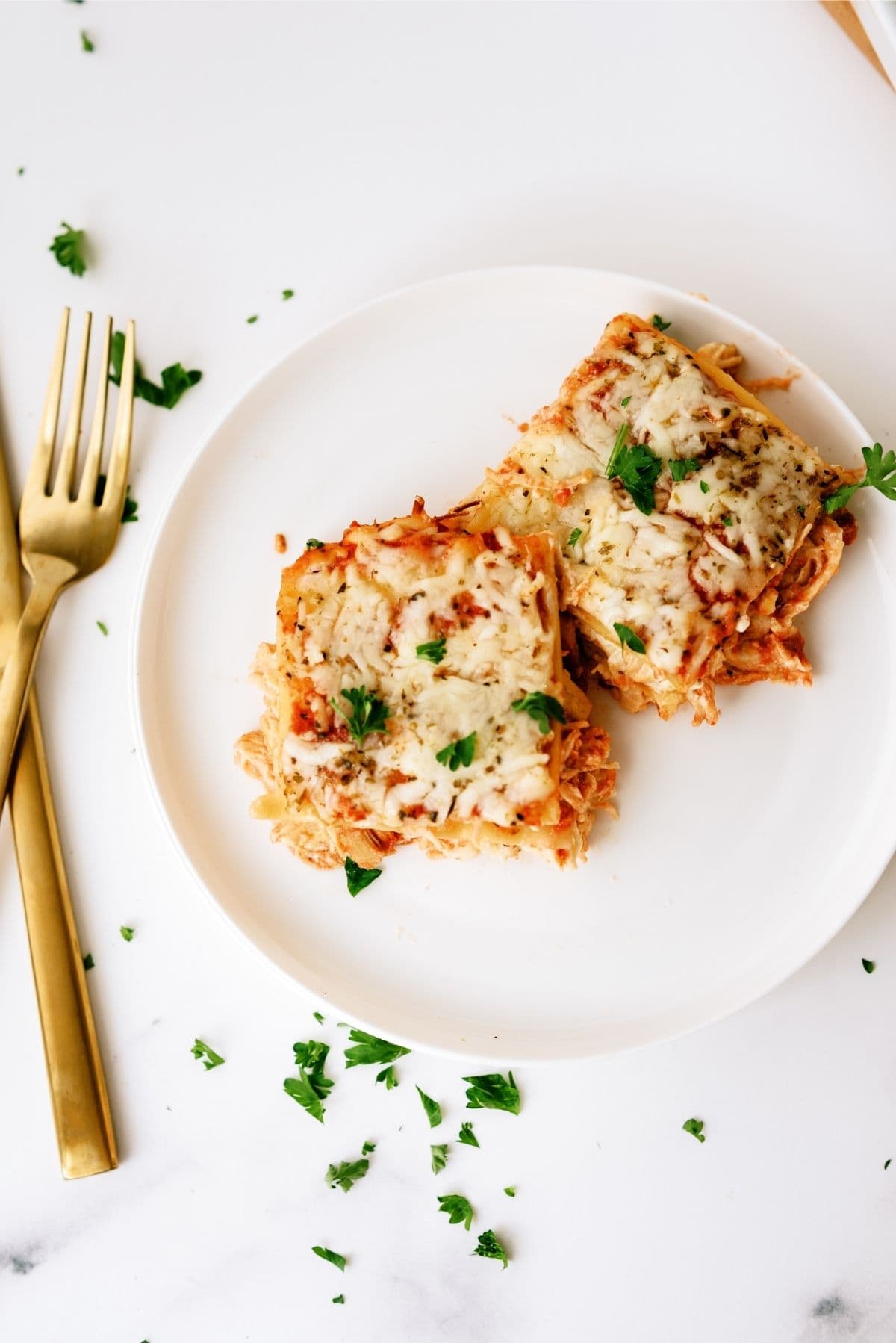 2 slices of Creamy Chicken Lasagna on a white plate