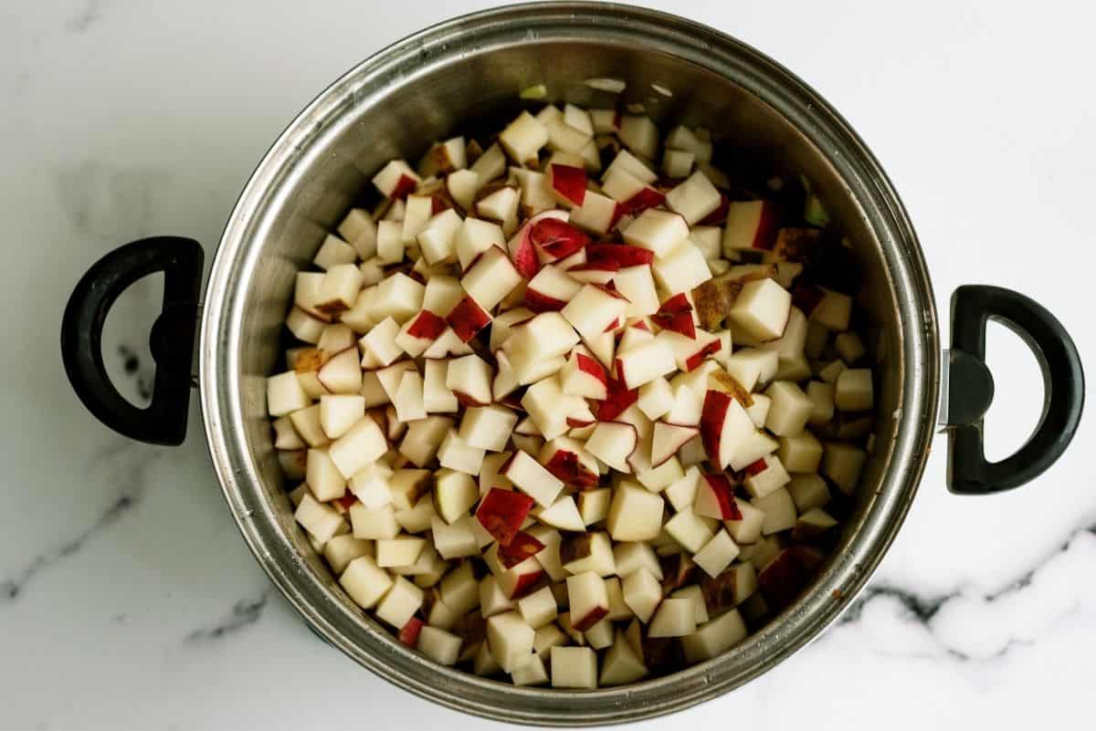 Adding diced potatoes to stock pot