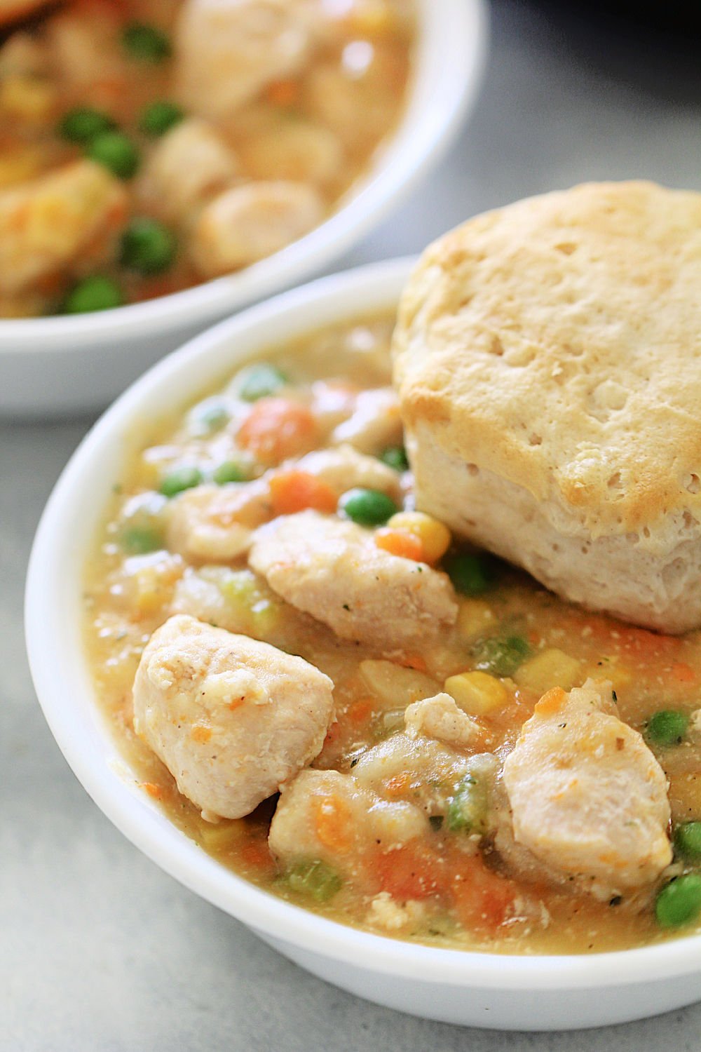 Instant Pot Chicken Pot Pie and Biscuits in a white bowl 
