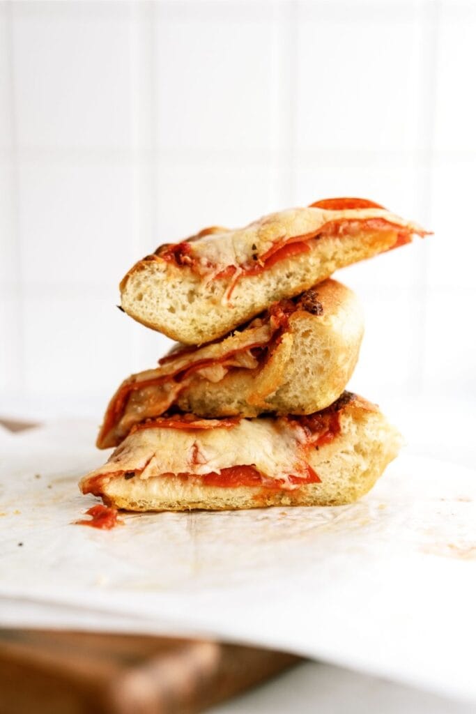 stacked slices of homemade deep dish pizza resting on a cutting board