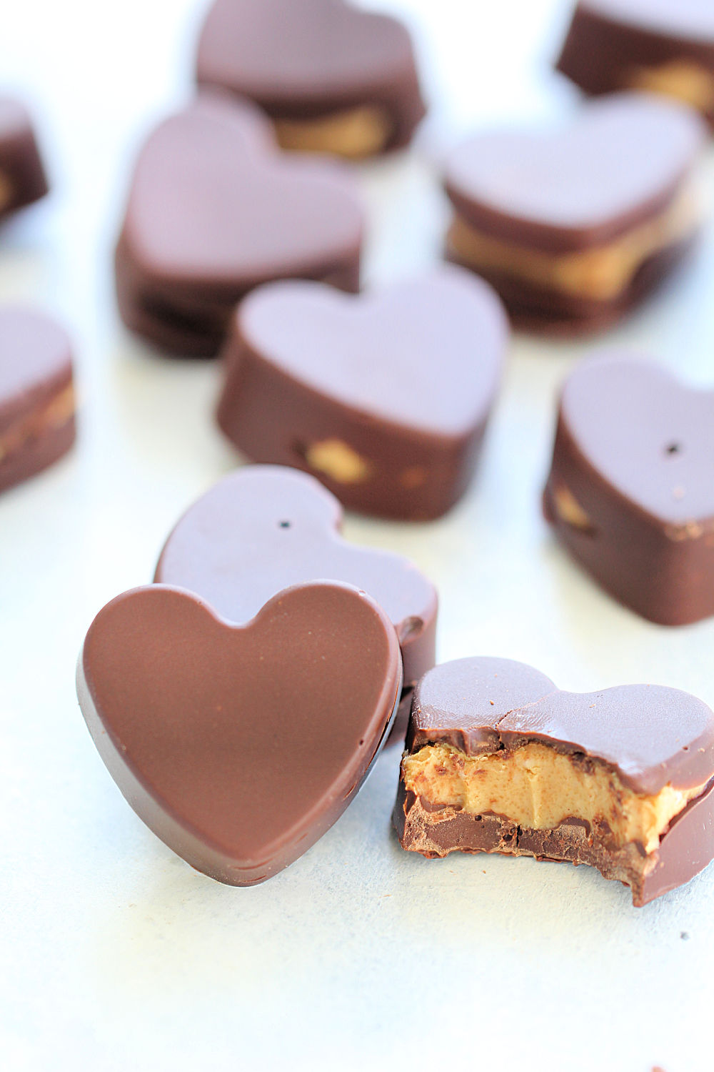 Peanut Butter Chocolate Hearts (Homemade Reese's) with a bite taken out of one heart